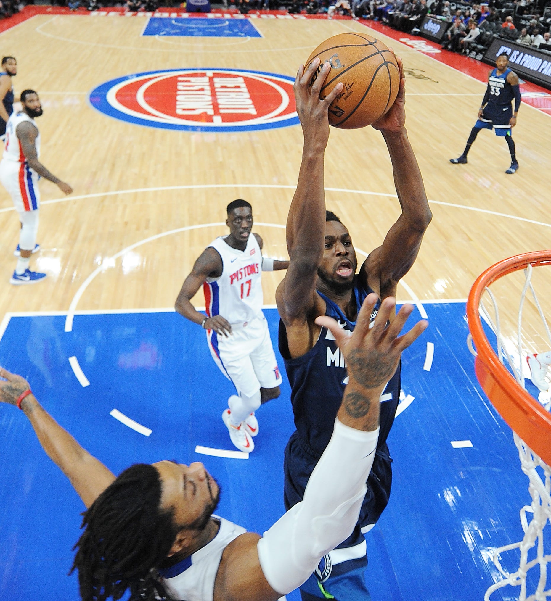 Timberwolves' Andrew Wiggins dunks over Pistons' Derrick Rose in the first quarter.