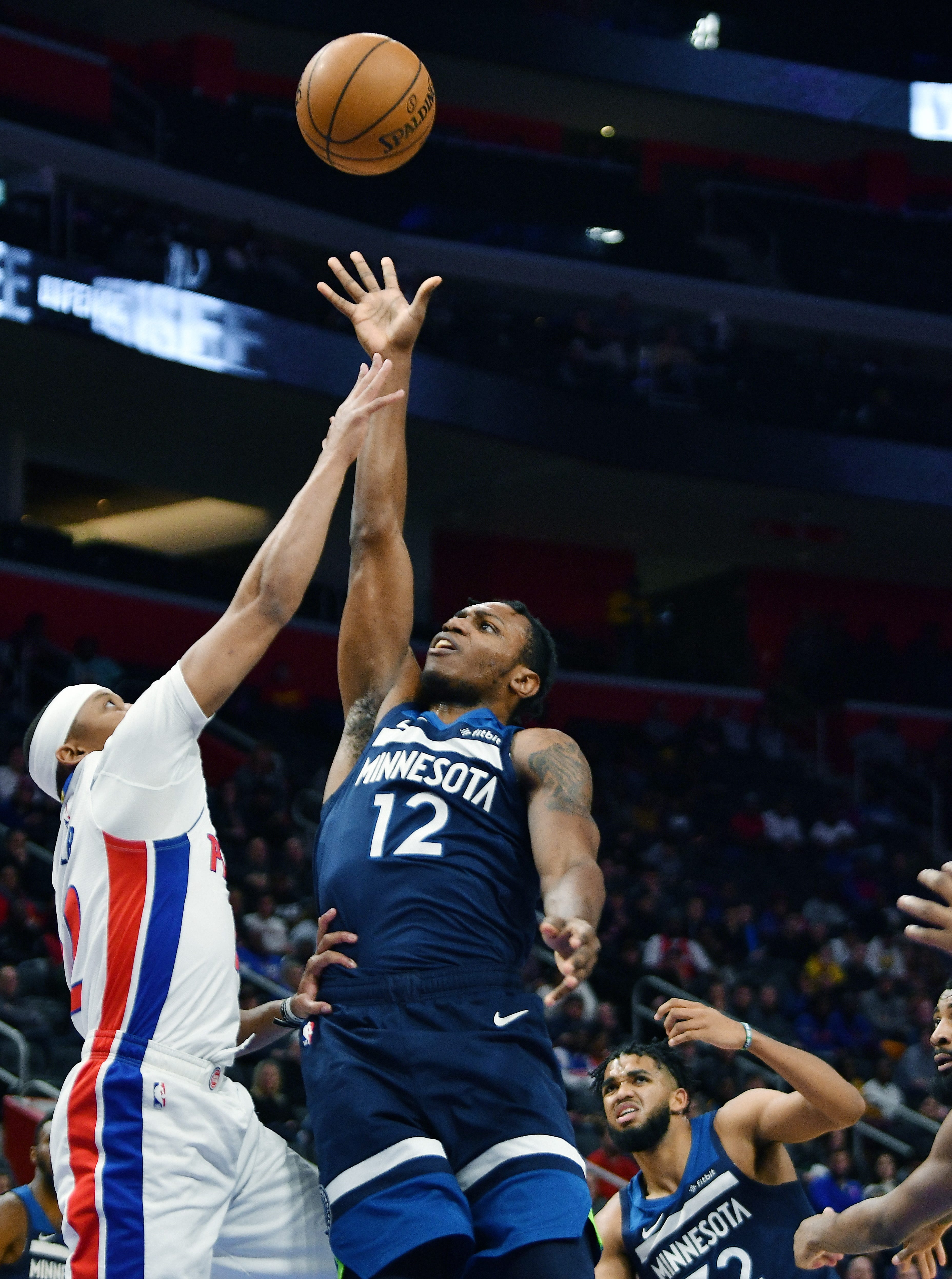 Timberwolves' Treveon Graham shoots over Pistons' Tim Frazier in the fourth quarter.