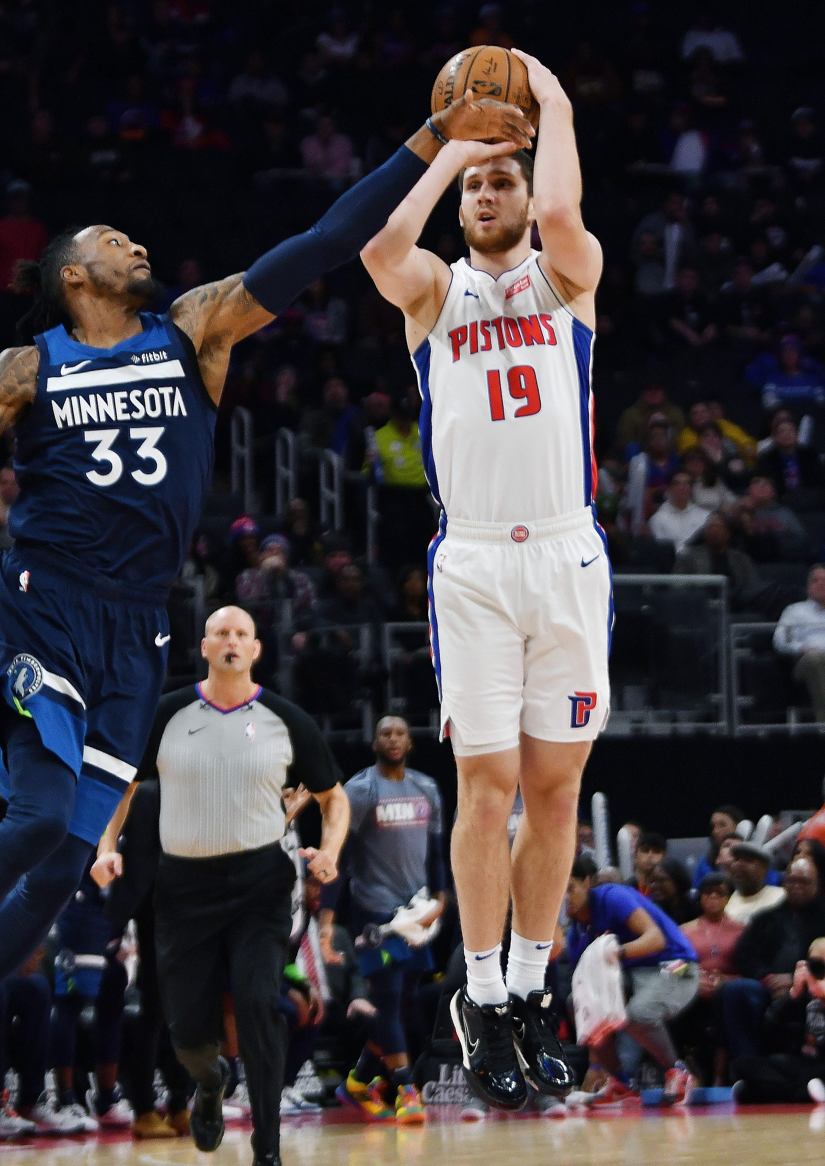 Pistons' Svi Mykhailiuk shoots over Timberwolves' Robert Covington in the first quarter.