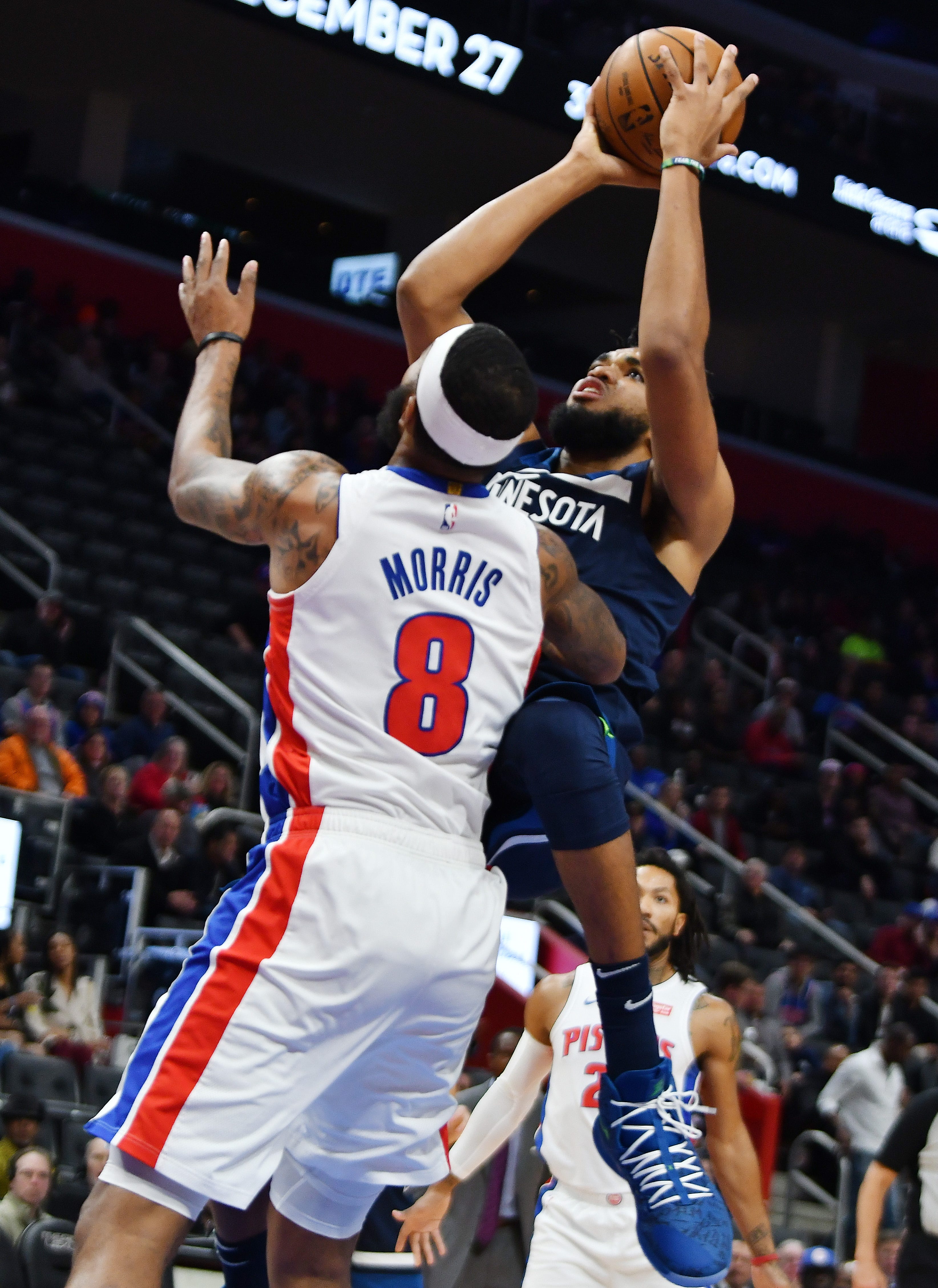 Timberwolves' Karl-Anthony Towns scores over Pistons' Markieff Morris in the fourth quarter.