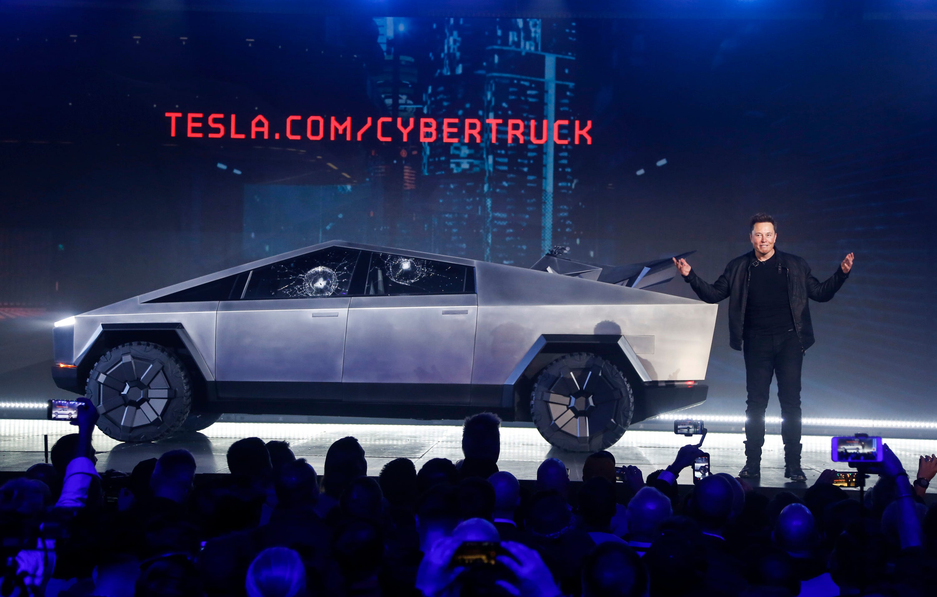 Tesla CEO Elon Musk introduces the Cybertruck at Tesla's design studio Thursday, Nov. 21, 2019, in Hawthorne, Calif. Musk is taking on the workhorse heavy pickup truck market with his latest electric vehicle.