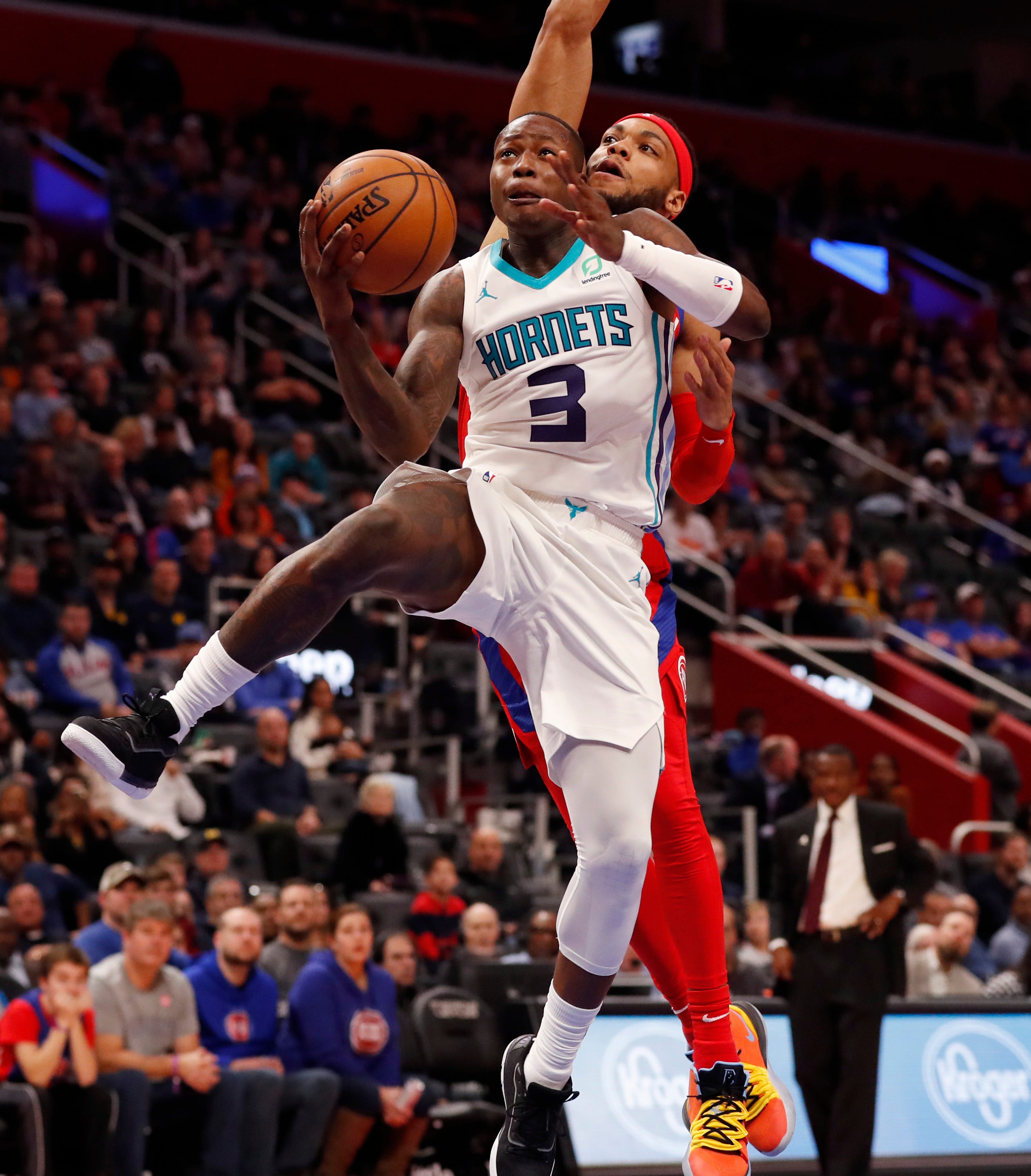 Hornets guard Terry Rozier attempts a layup as Pistons guard Bruce Brown defends.