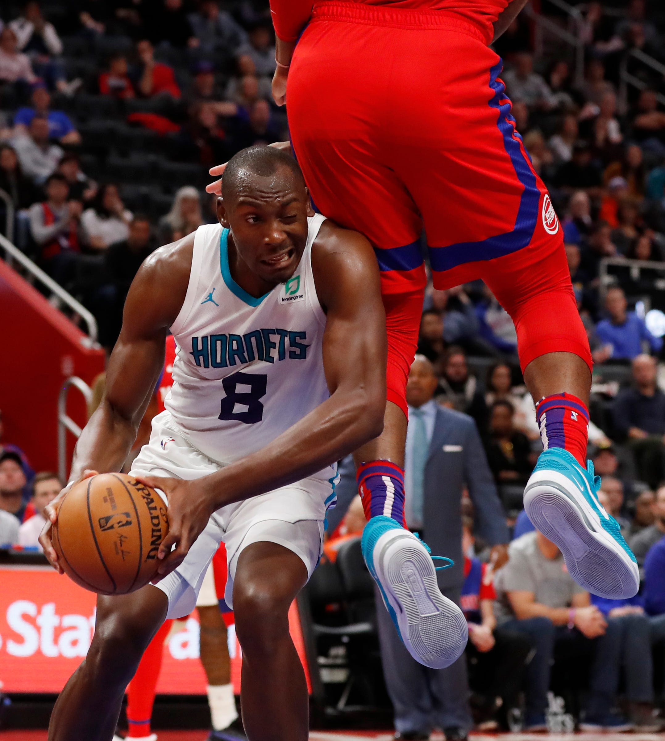 Hornets center Bismack Biyombo is fouled by Pistons center Andre Drummond during the second half.