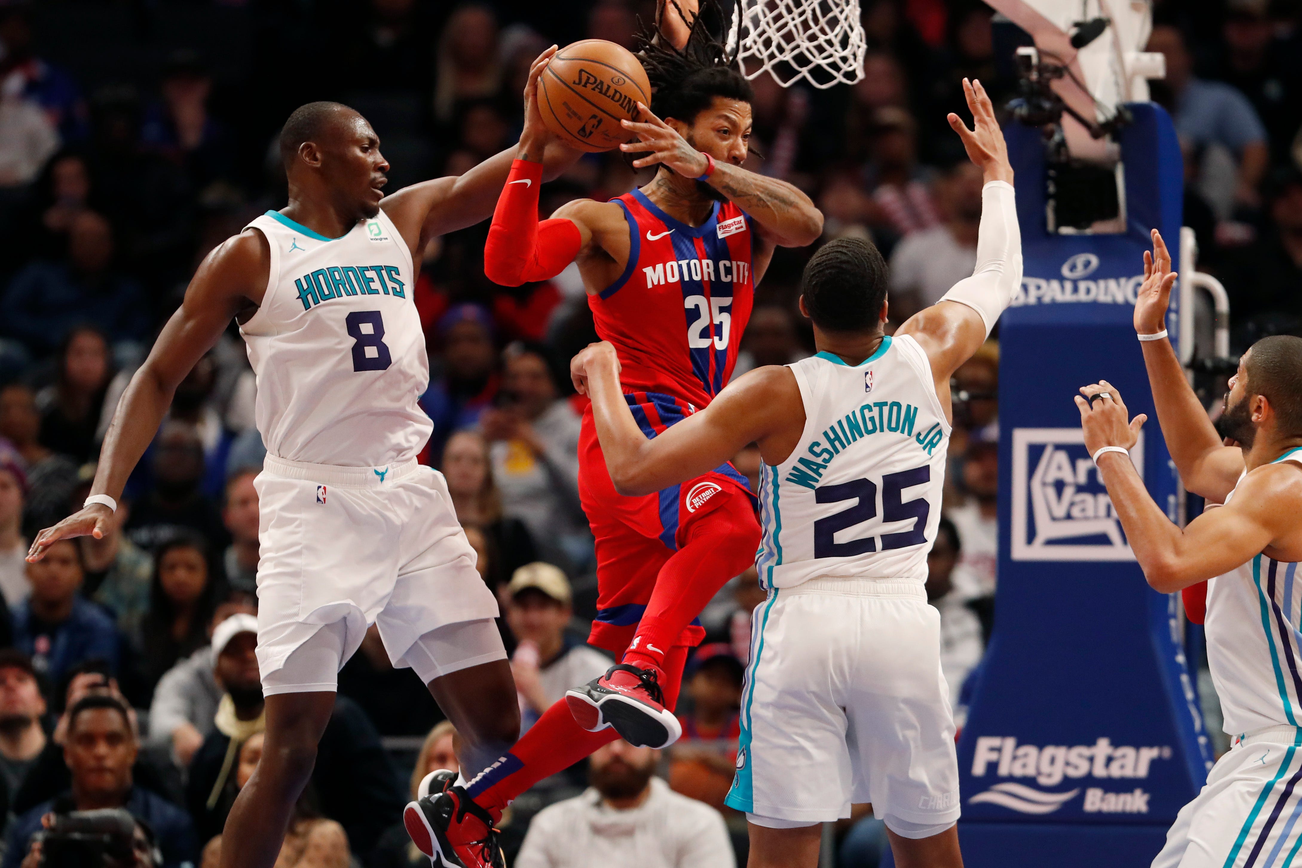 Pistons guard Derrick Rose passes the ball as Hornets center Bismack Biyombo (8) and forward PJ Washington defend