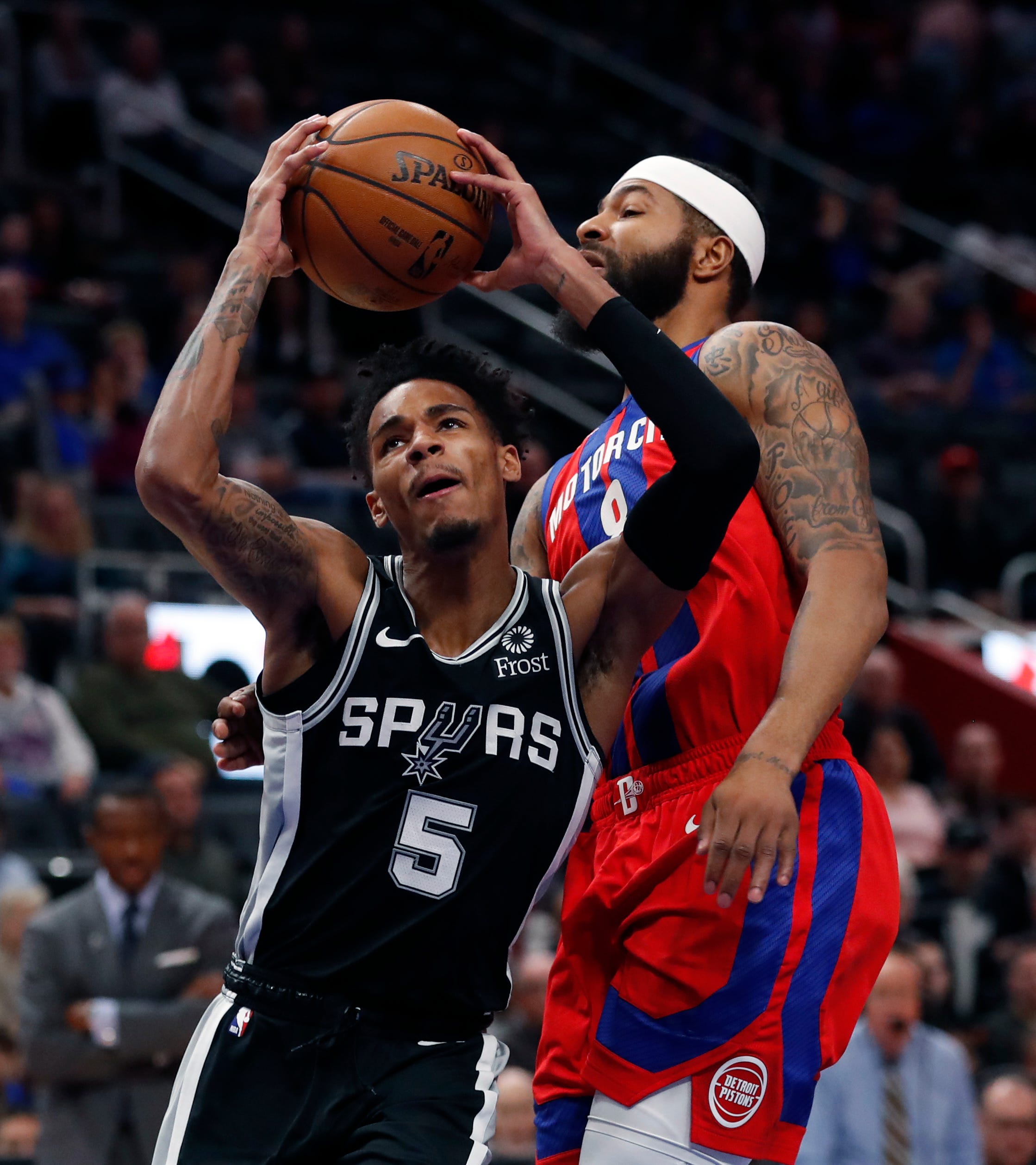 San Antonio Spurs guard Dejounte Murray (5) attempts a layup as Detroit Pistons forward Markieff Morris (8) defends during the first half.