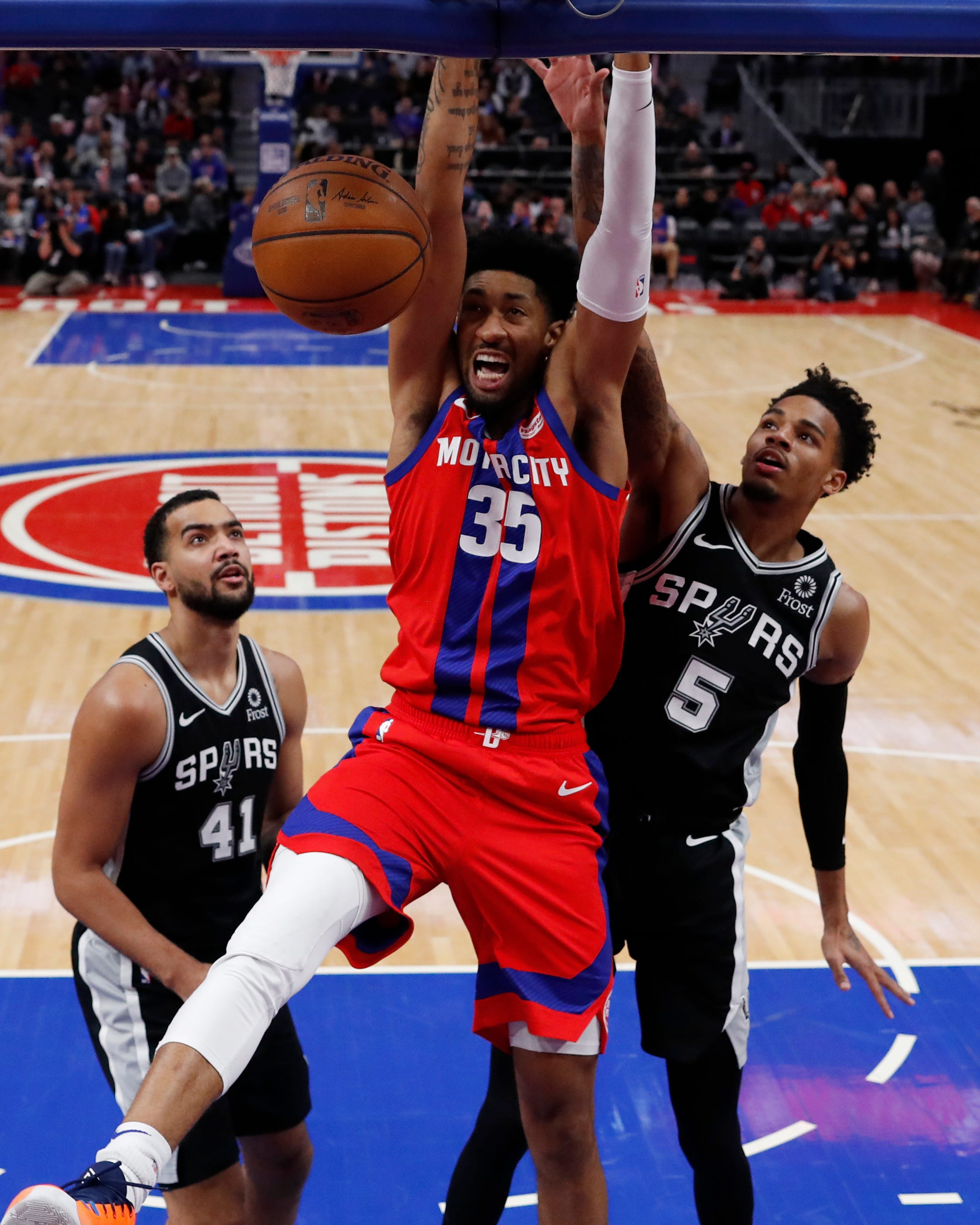 Detroit Pistons forward Christian Wood (35) dunks as San Antonio Spurs guard Dejounte Murray (5) defends during the second half of the Pistons ' 132-98 victory on Sunday, Dec. 1, 2019, in Detroit.