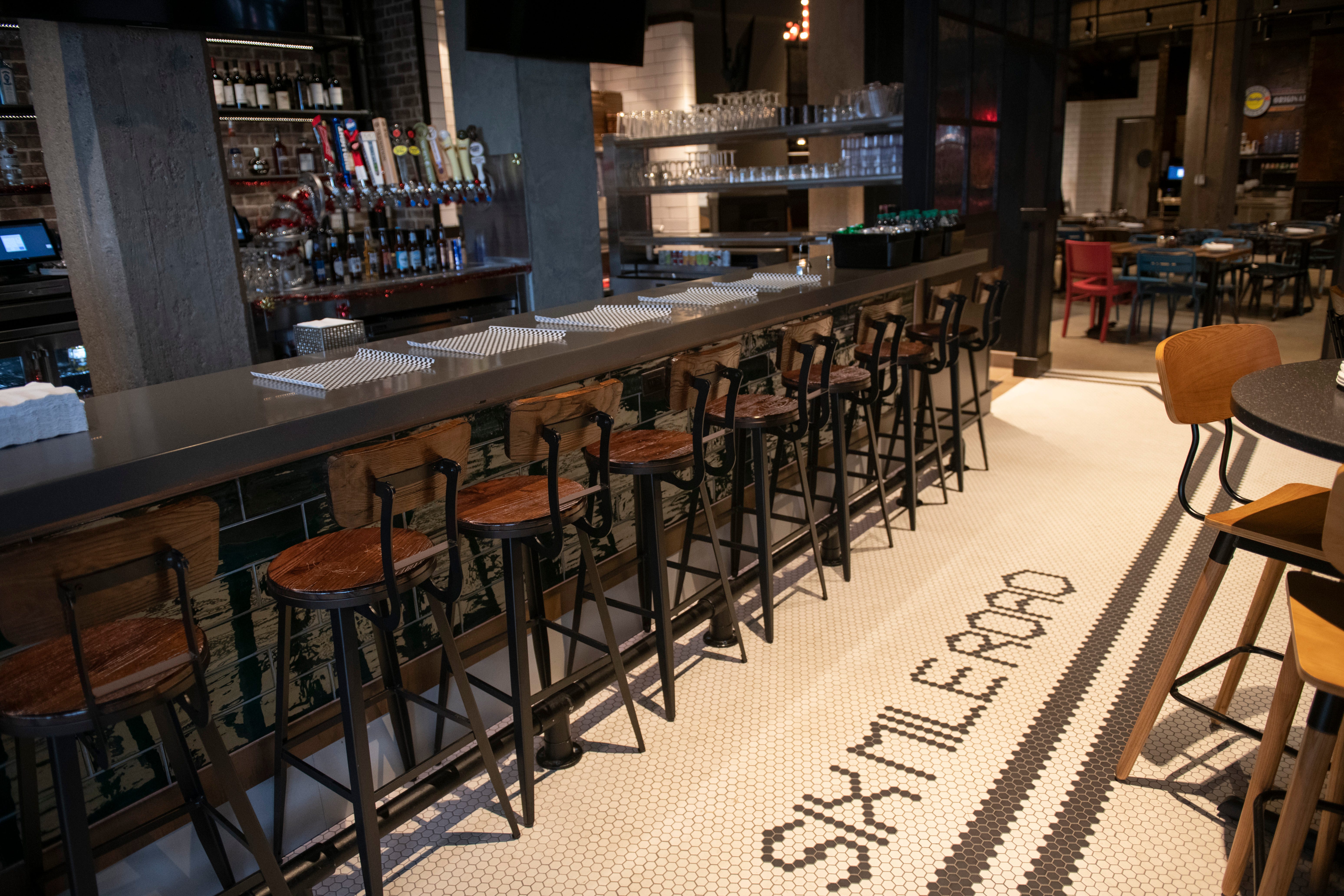 'Six Mile Road' is seen in the floor tile in the bar area inside Buddy's Pizza's new downtown restaurant, a nod to the original 1946 Buddy's Pizza being located at Six Mile and Conant streets.
