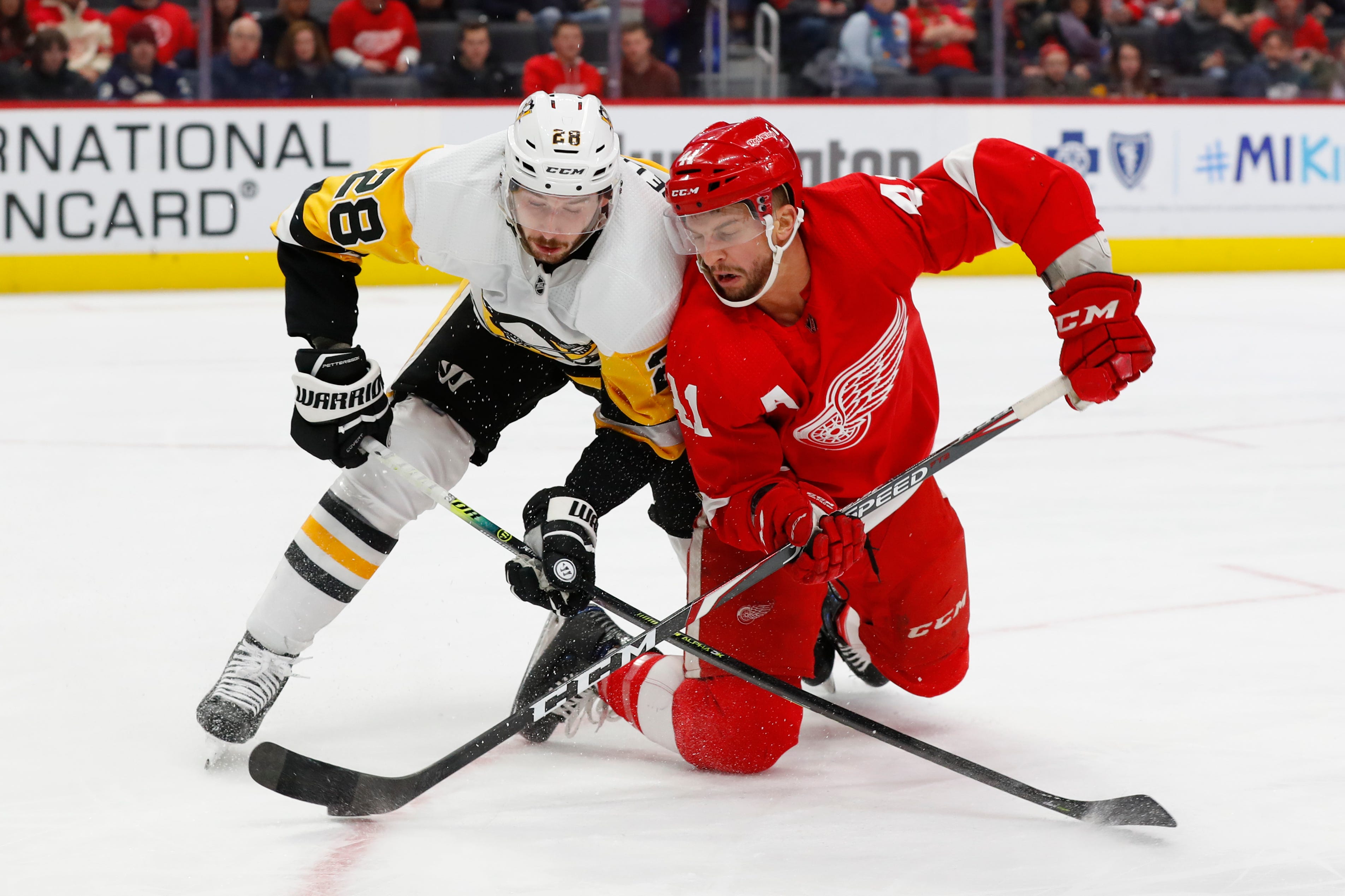 Pittsburgh Penguins defenseman Marcus Pettersson (28) and Detroit Red Wings center Luke Glendening (41) battle for the puck in the second period.