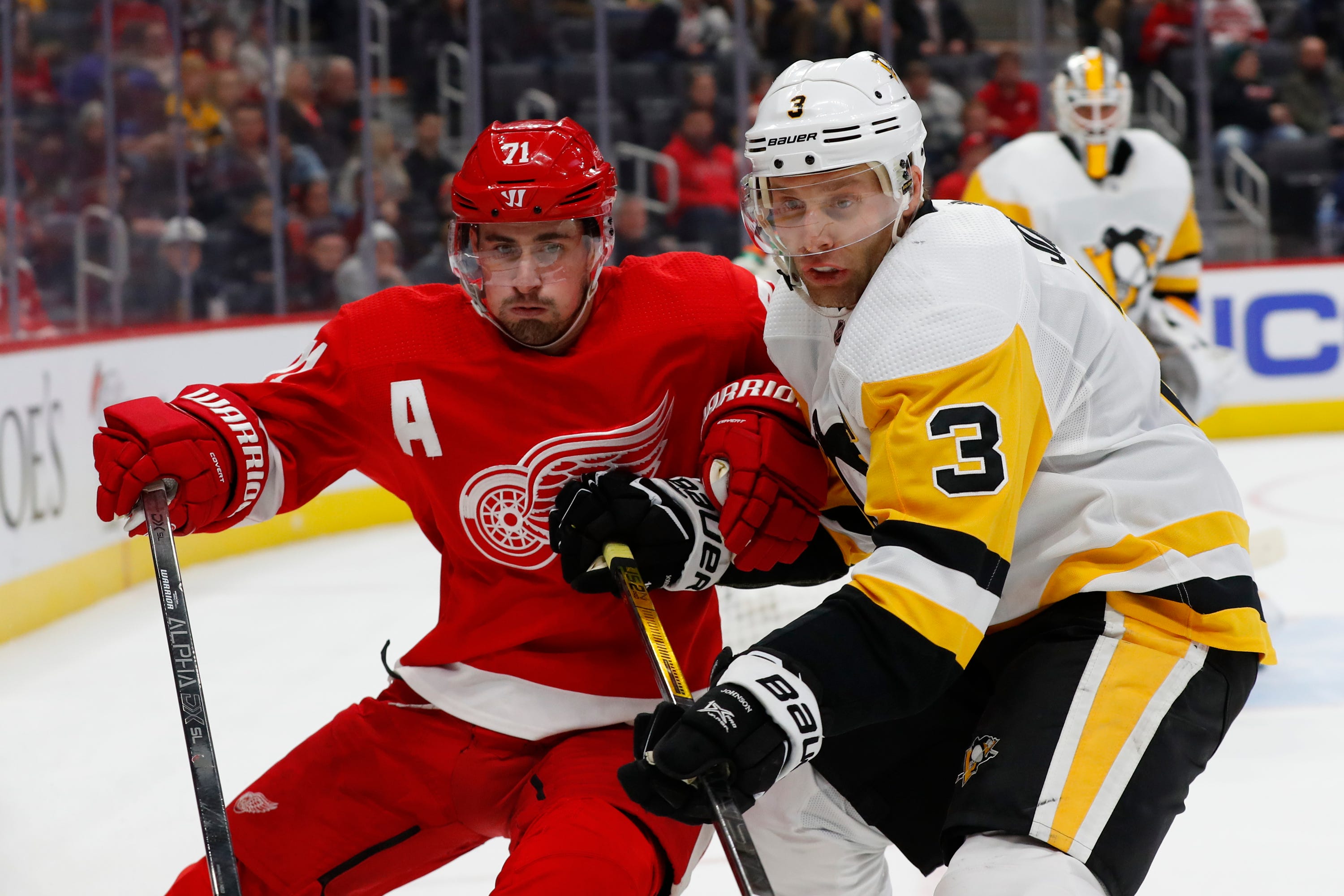 Detroit Red Wings center Dylan Larkin (71) and Pittsburgh Penguins defenseman Jack Johnson (3) battle for position in the second period.