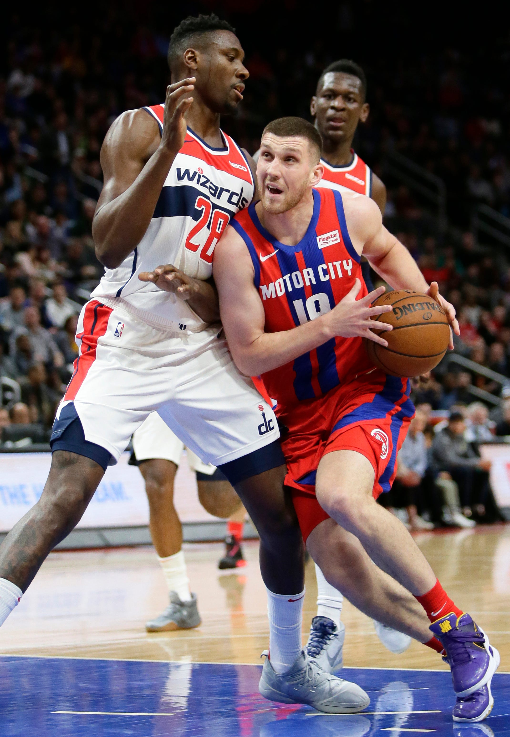 Detroit Pistons guard Sviatoslav Mykhailiuk (19) drives against Washington Wizards center Ian Mahinmi (28) during the first half.