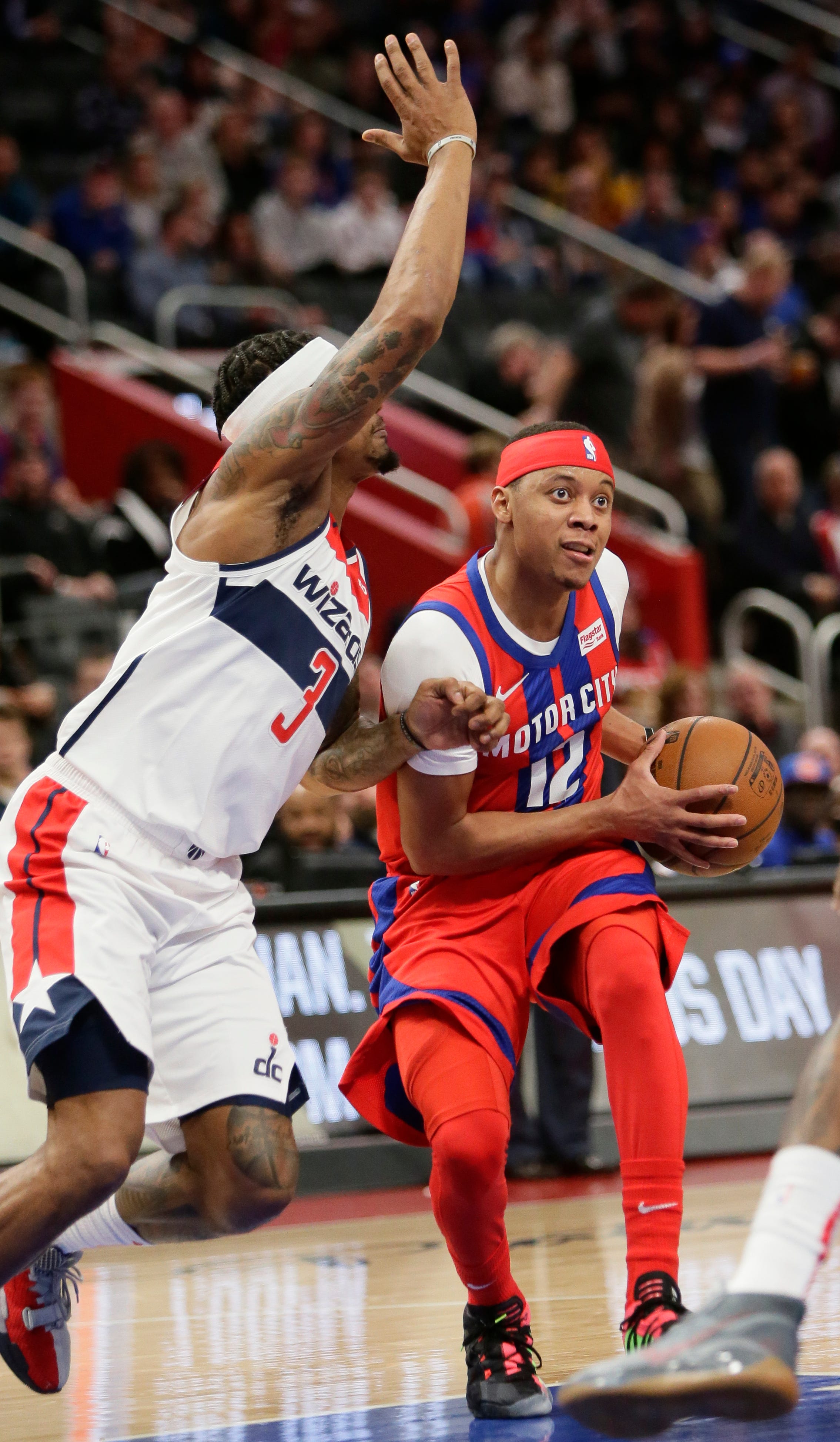 Detroit Pistons guard Tim Frazier (12) is defended by Washington Wizards guard Bradley Beal (3) during the first half.