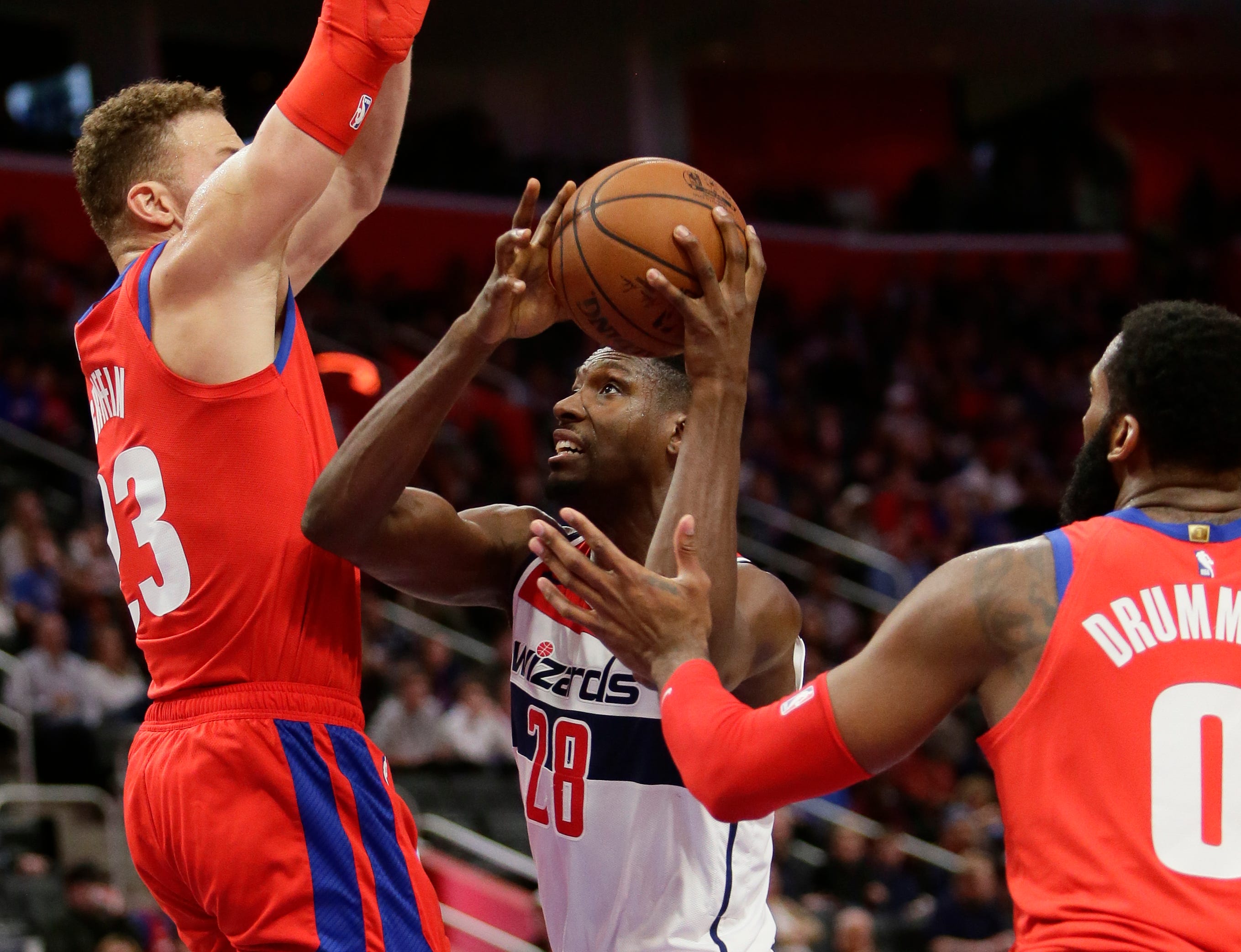 Washington Wizards center Ian Mahinmi (28) tries going to the basket against Detroit Pistons forward Blake Griffin, left, and Andre Drummond (0) during the second half.