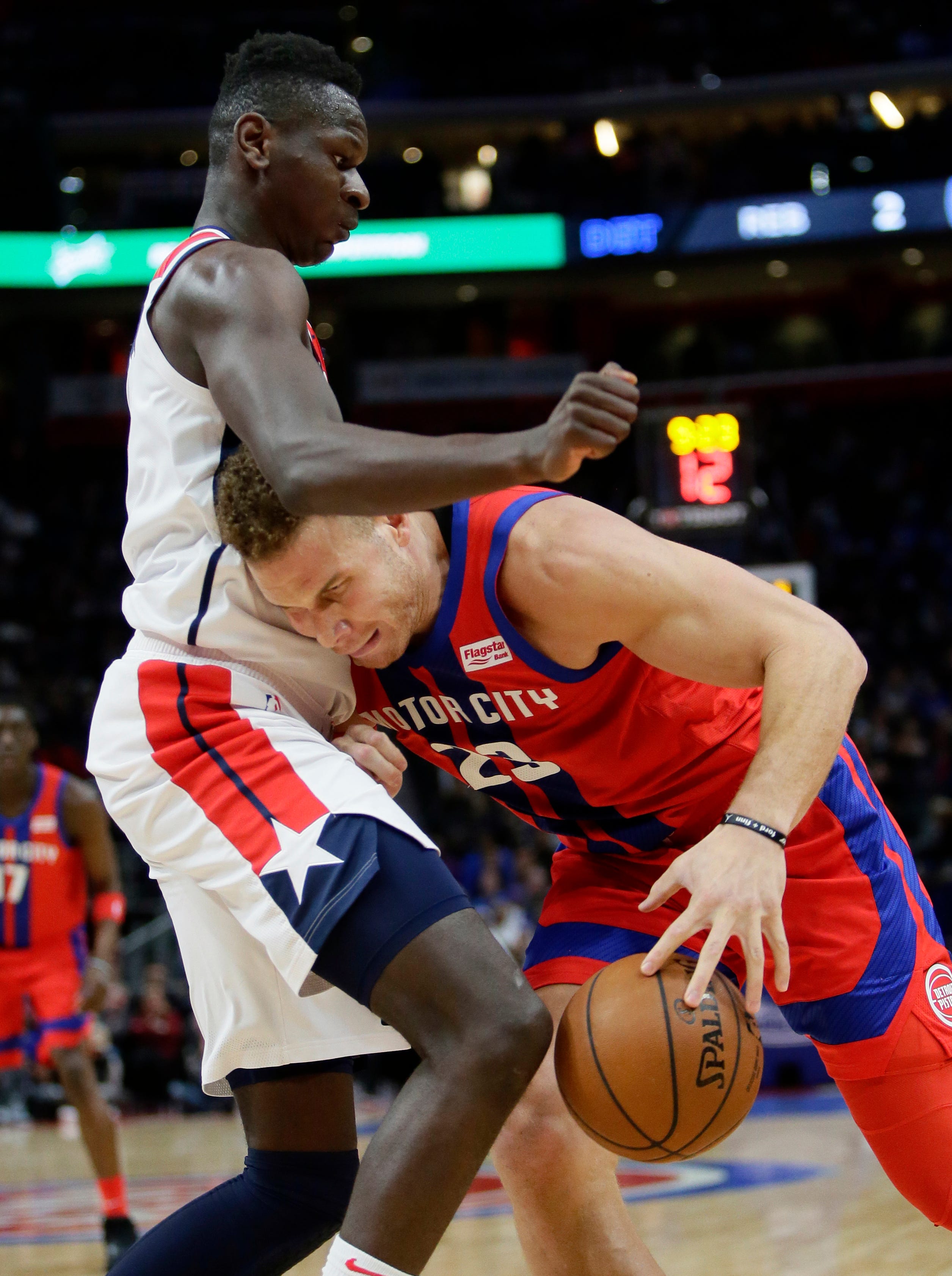 Detroit Pistons forward Blake Griffin (23) collides with Washington Wizards guard Isaac Bonga, top, while trying to go to the basket during the first half.
