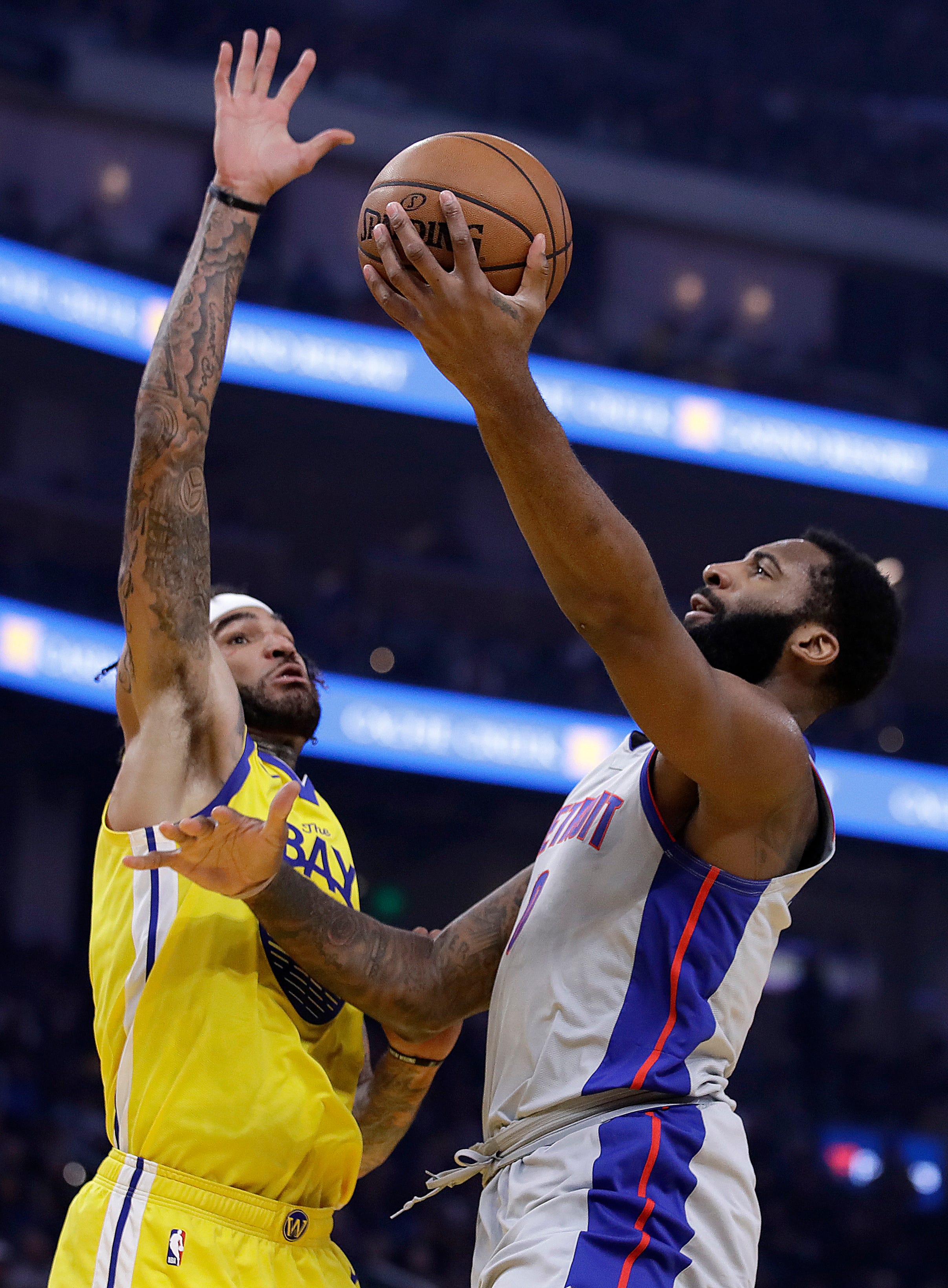 Detroit Pistons' Andre Drummond, right, lays up a shot against Golden State Warriors' Willie Cauley-Stein during the first half.