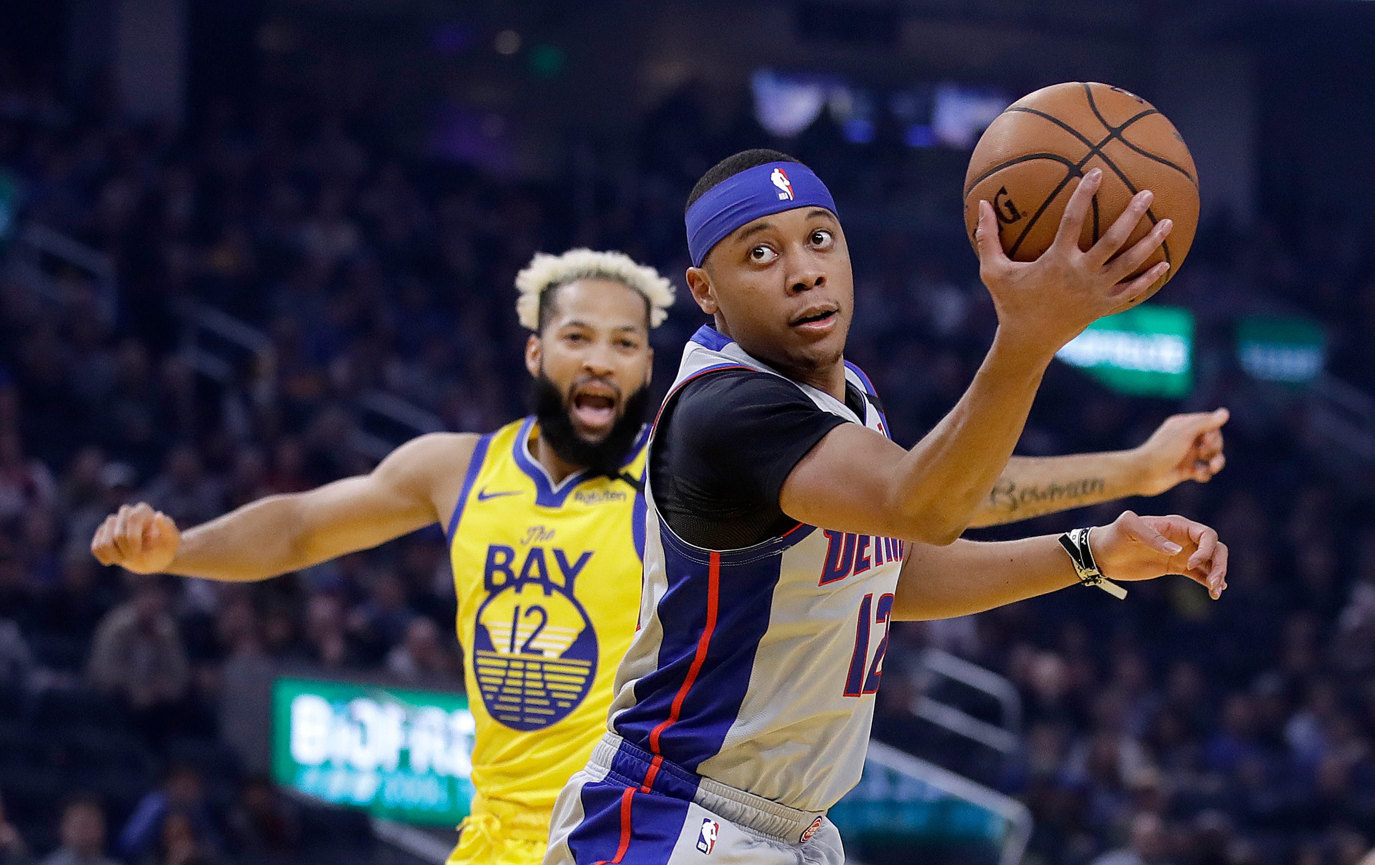 Detroit Pistons' Tim Frazier, right, looks to shoot past Golden State Warriors' Ky Bowman during the first half of an NBA basketball game Saturday, Jan. 4, 2020, in San Francisco.