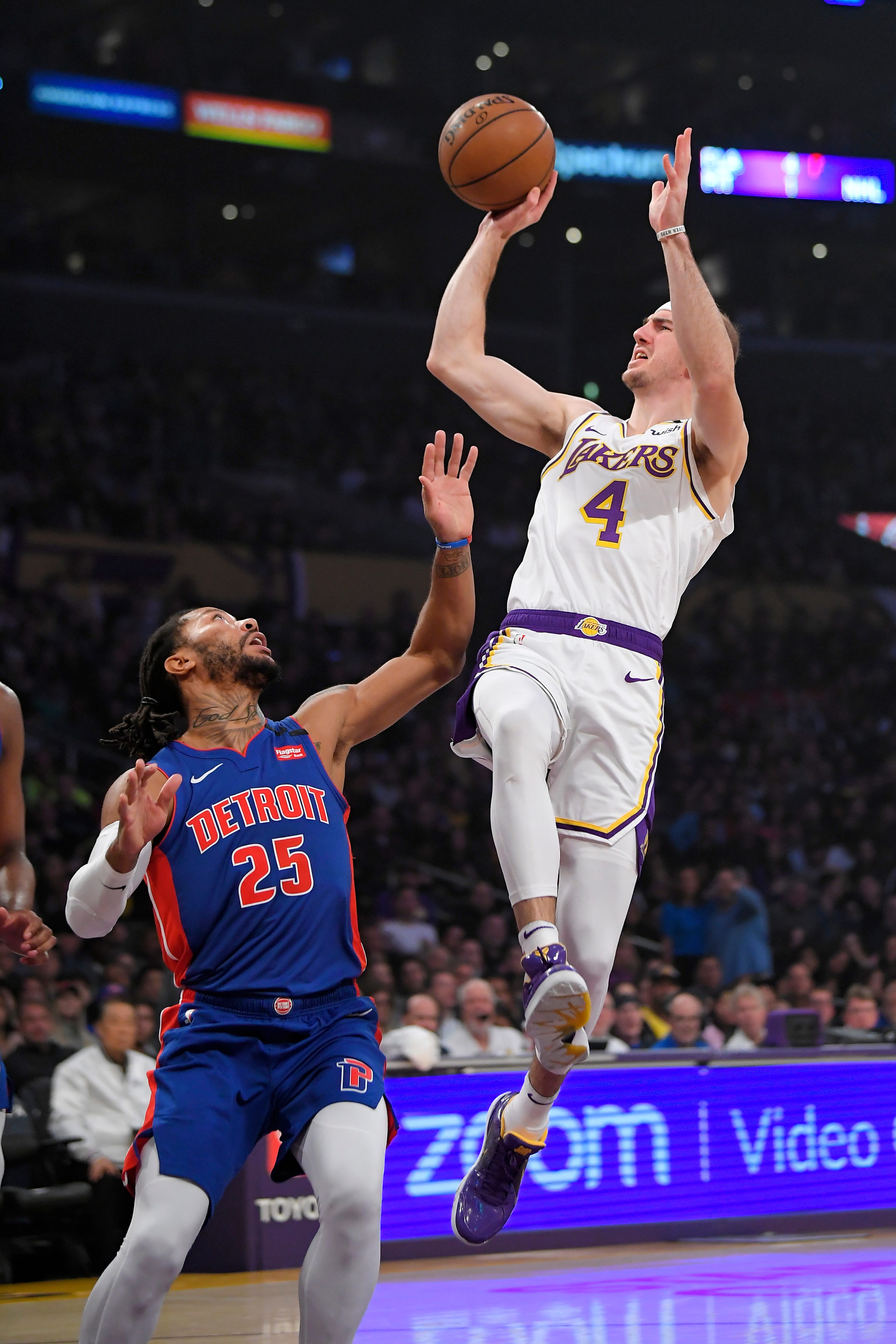 Los Angeles Lakers guard Alex Caruso, right, shoots as Detroit Pistons guard Derrick Rose defends during the first half.