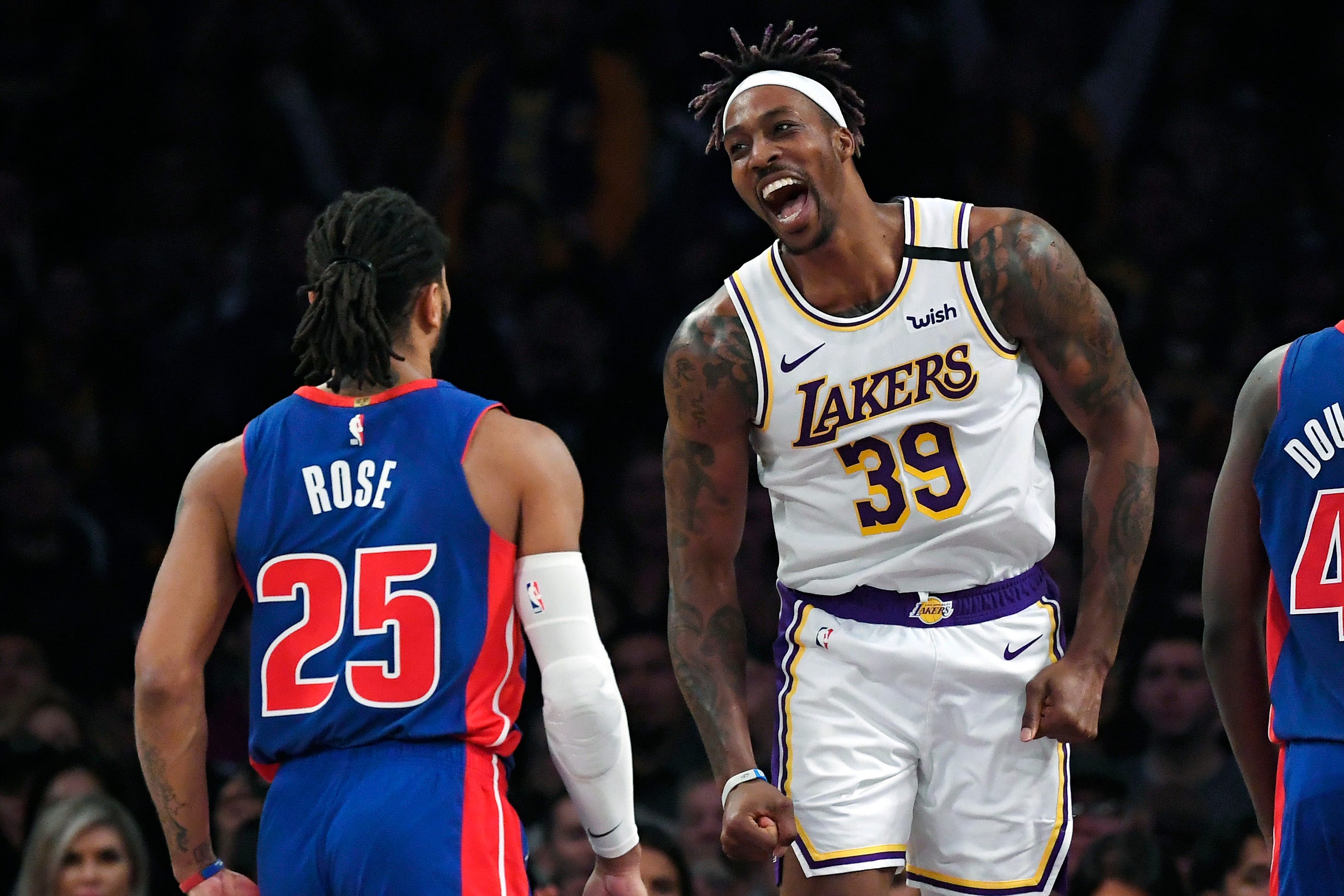 Los Angeles Lakers center Dwight Howard (39) celebrates after scoring toward Detroit Pistons guard Derrick Rose (25) during the second half of an NBA basketball game, Sunday, Jan. 5, 2020, in Los Angeles. The Lakers won 106-99.