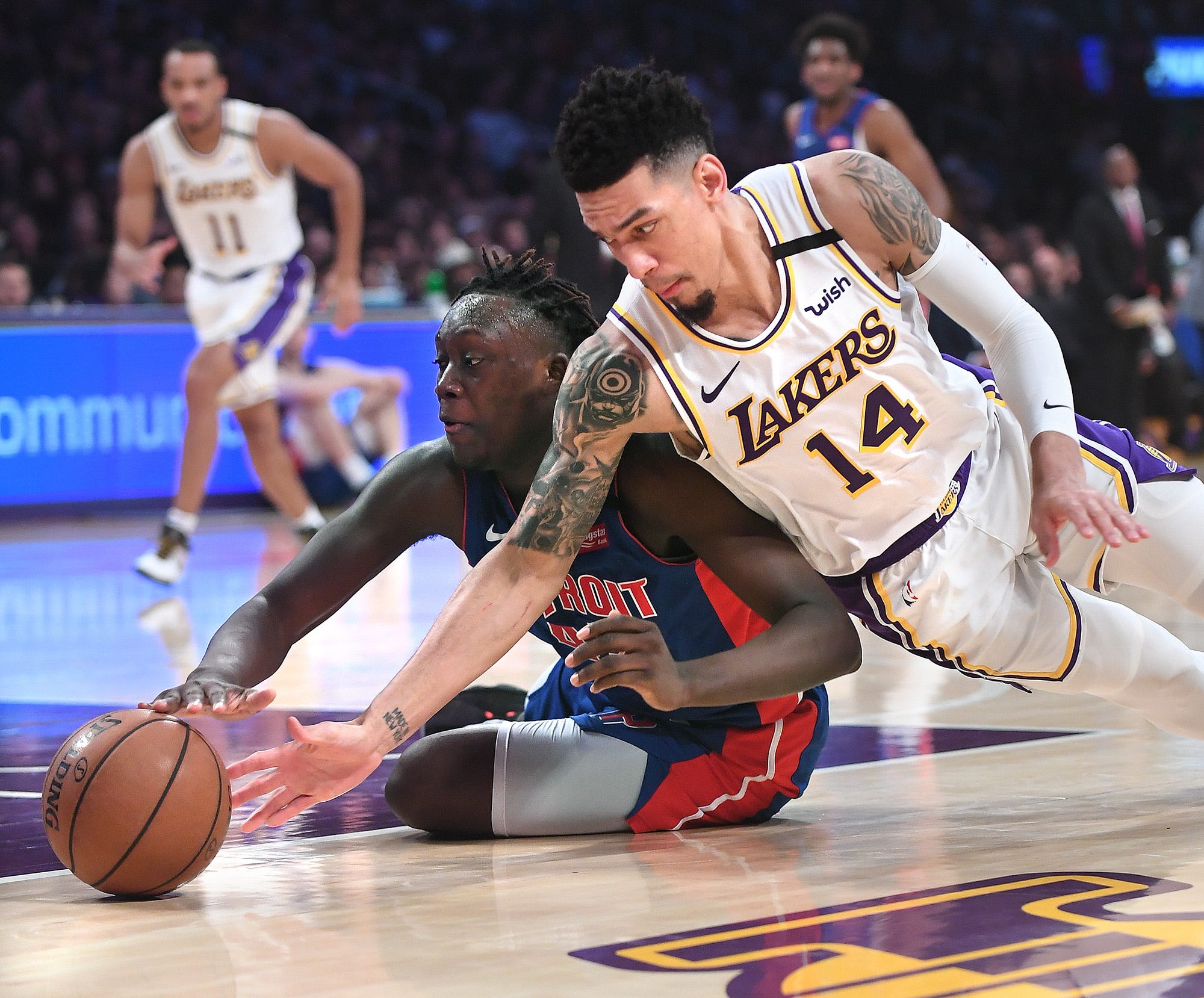 Los Angeles Lakers' Danny Green and Detroit Pistons' Sekou Doumbouya battle for a loose ball in the second quarter.