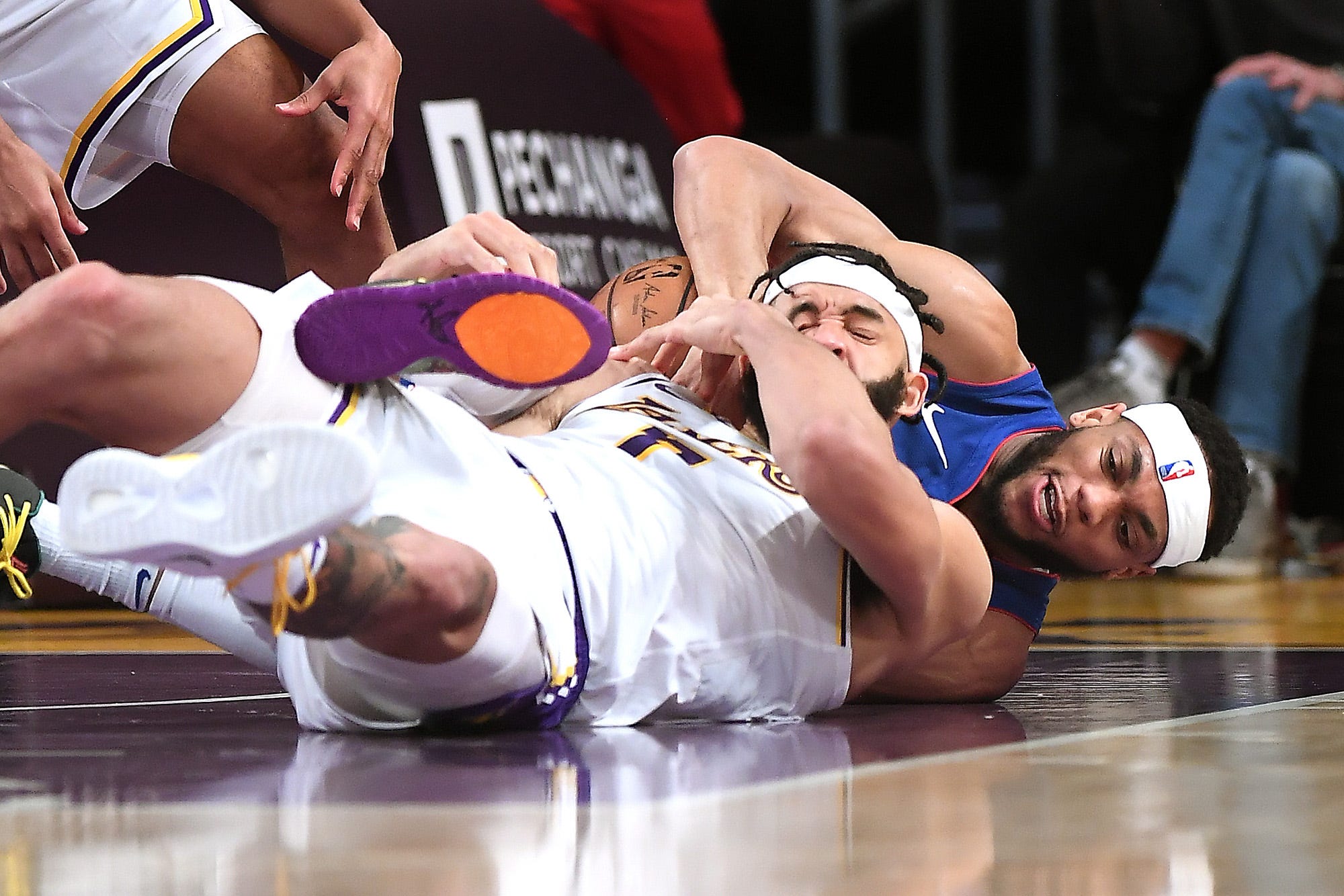 Los Angeles Lakers' JaVale McGee and Detroit Pistons' Bruce Brown battle for a loose ball in the second quarter.