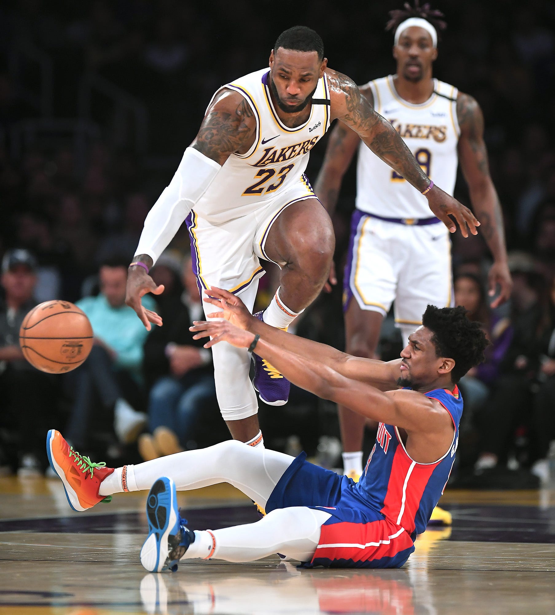 Los Angeles Lakers' LeBron James and Detroit Pistons' Langston Galloway battle for a loose ball in the second quarter.