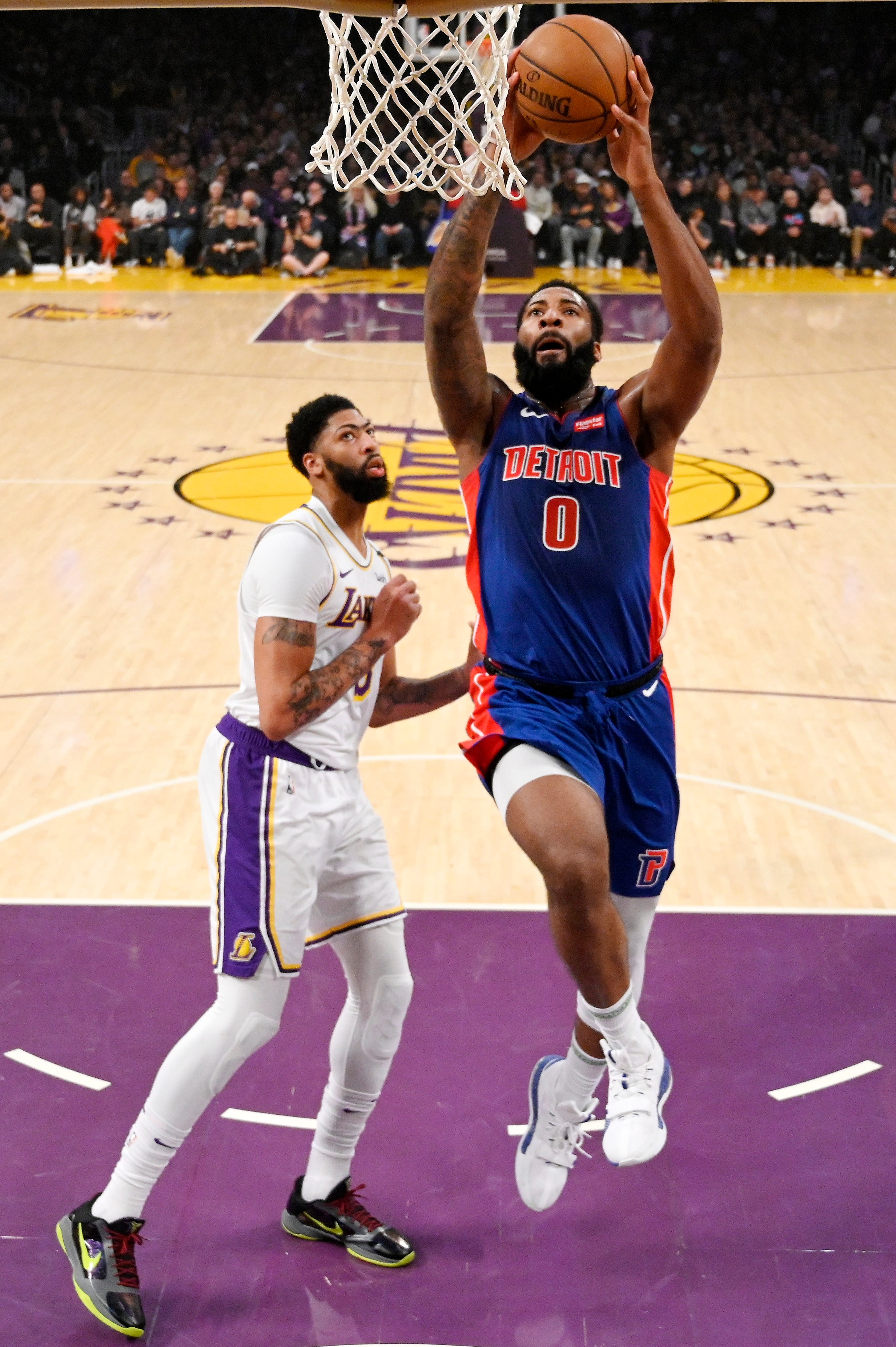 Detroit Pistons center Andre Drummond, right, dunks as Los Angeles Lakers forward Anthony Davis watches during the first half.