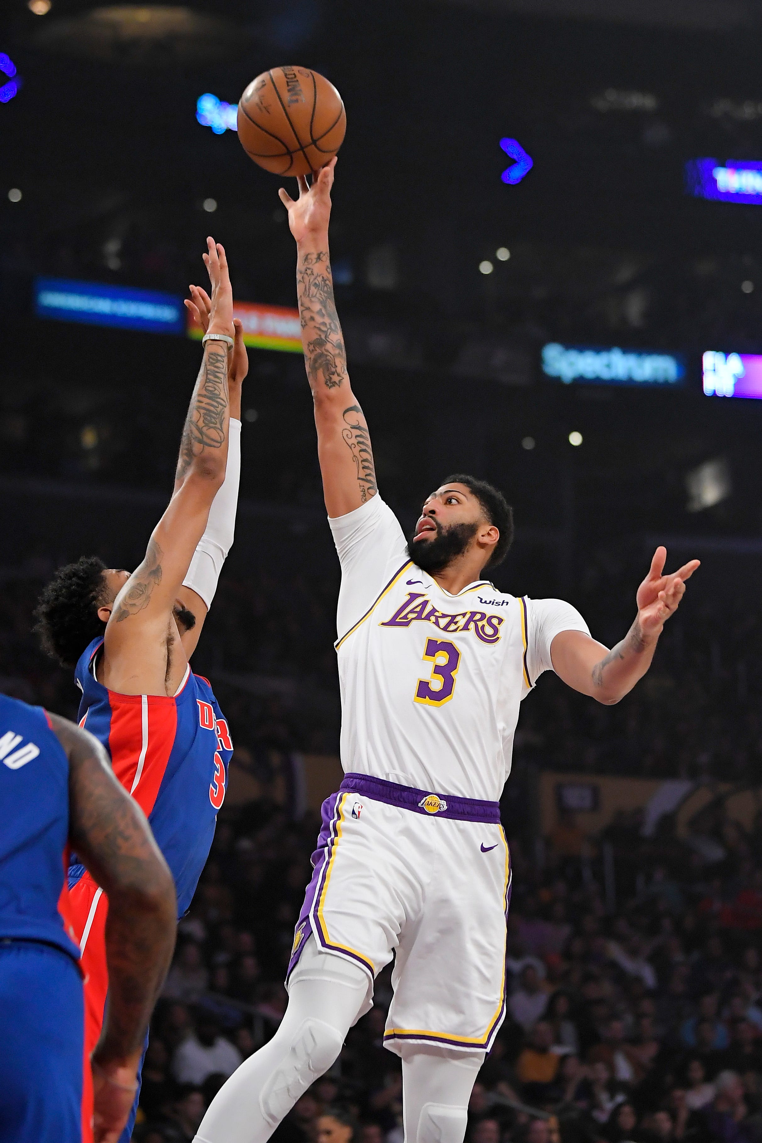 Los Angeles Lakers forward Anthony Davis, right, shoots as Detroit Pistons forward Christian Wood defends during the first half.