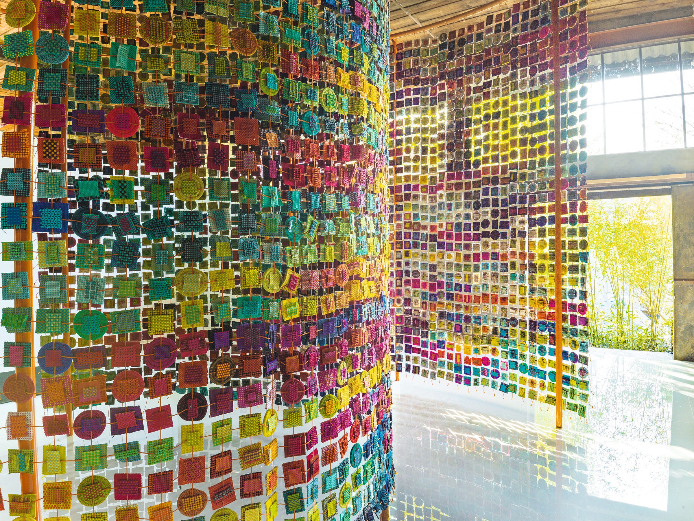Master textile artist Paola Lenti created this extraordinary room divider out of small samples of her fabrics with stitchery showing a range of her extensive color palette.