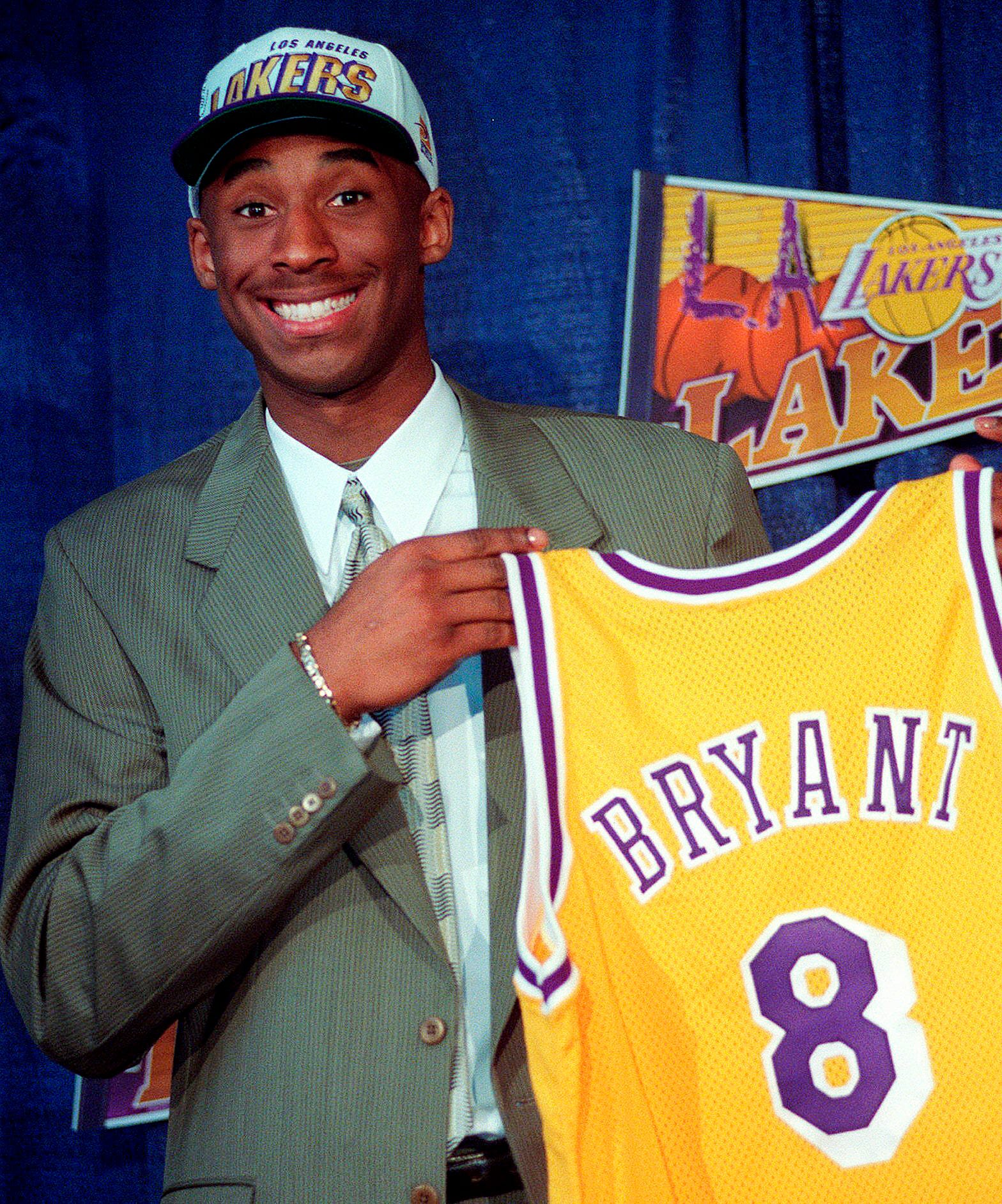 Kobe Bryant, 17, holds his jersey during a 1996 press conference.