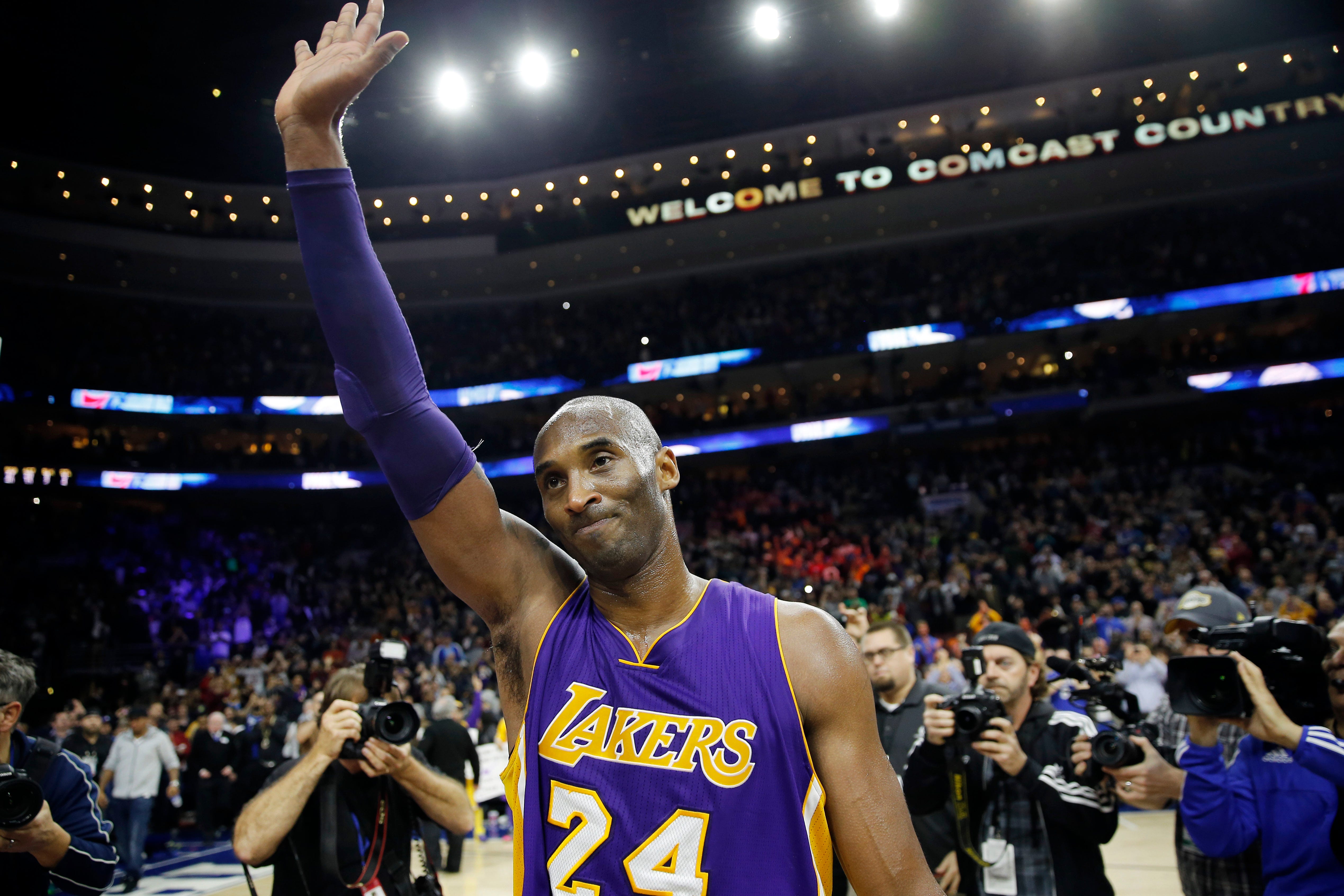 Kobe Bryant waves to the crowd after an NBA game in Philadelphia in 2015.