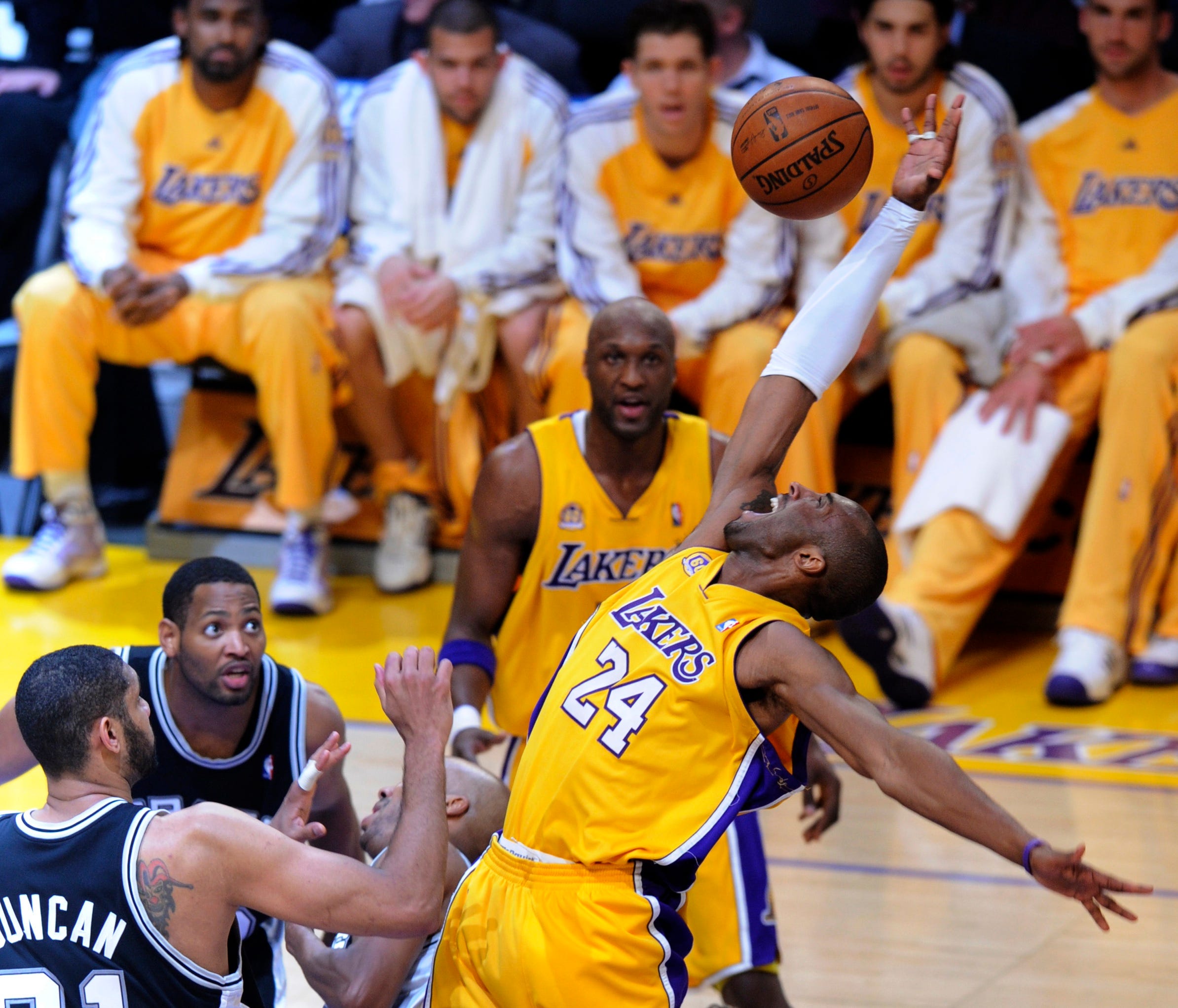Kobe Bryant, right, loses the ball as he drives on Tim Duncan in the 2008 NBA playoffs.