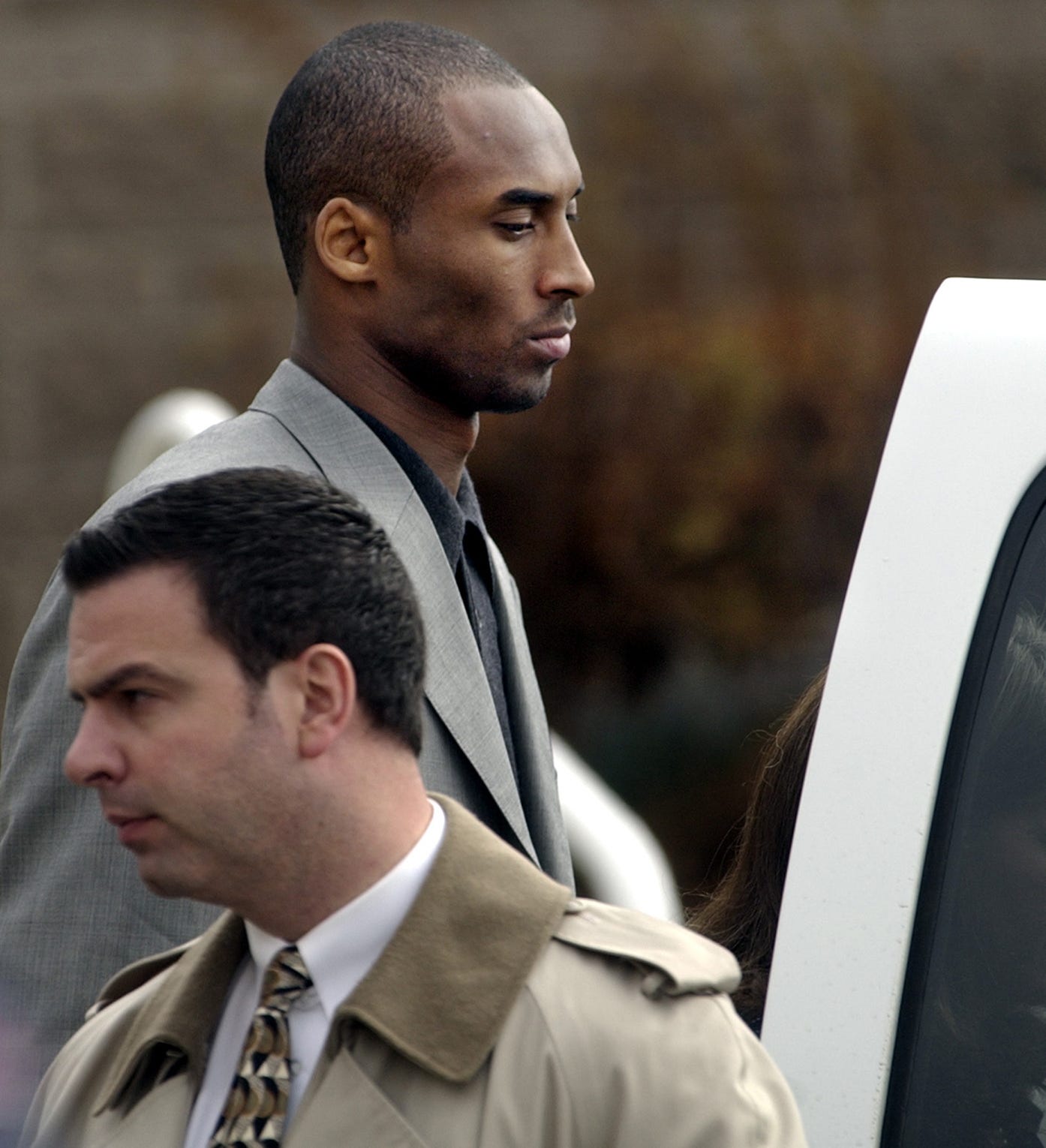 Kobe Bryant leaves court accompanied by security at the Justice Center in Eagle, Colo, on Nov. 13, 2003. He was accused of sexual assault, but the case was dropped.