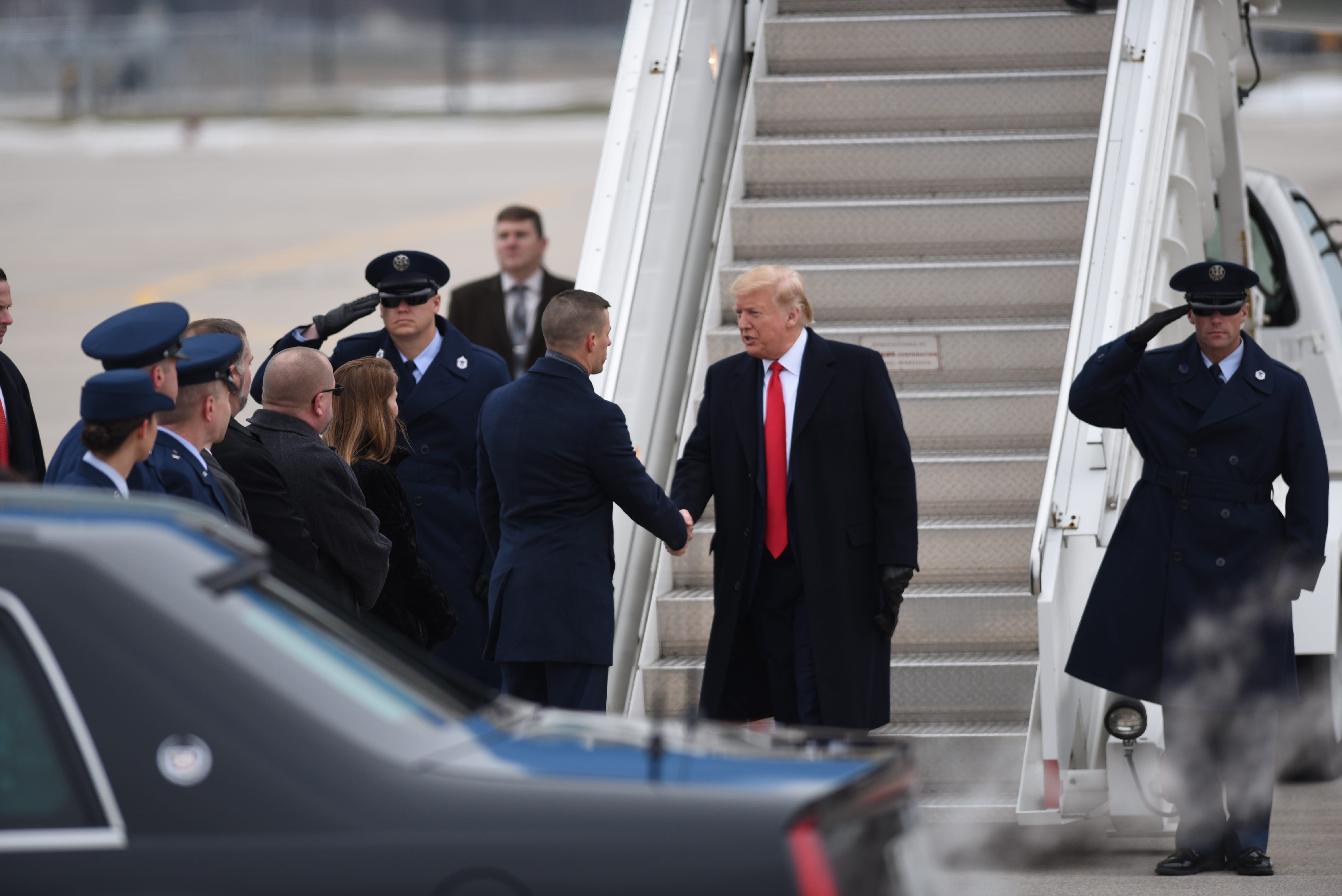 President Donald Trump is greeted by Michigan Speaker of the House Lee Chatfield upon arrival at Selfridge Air Base in Harrison Township on Thursday, Jan. 30, 2020.