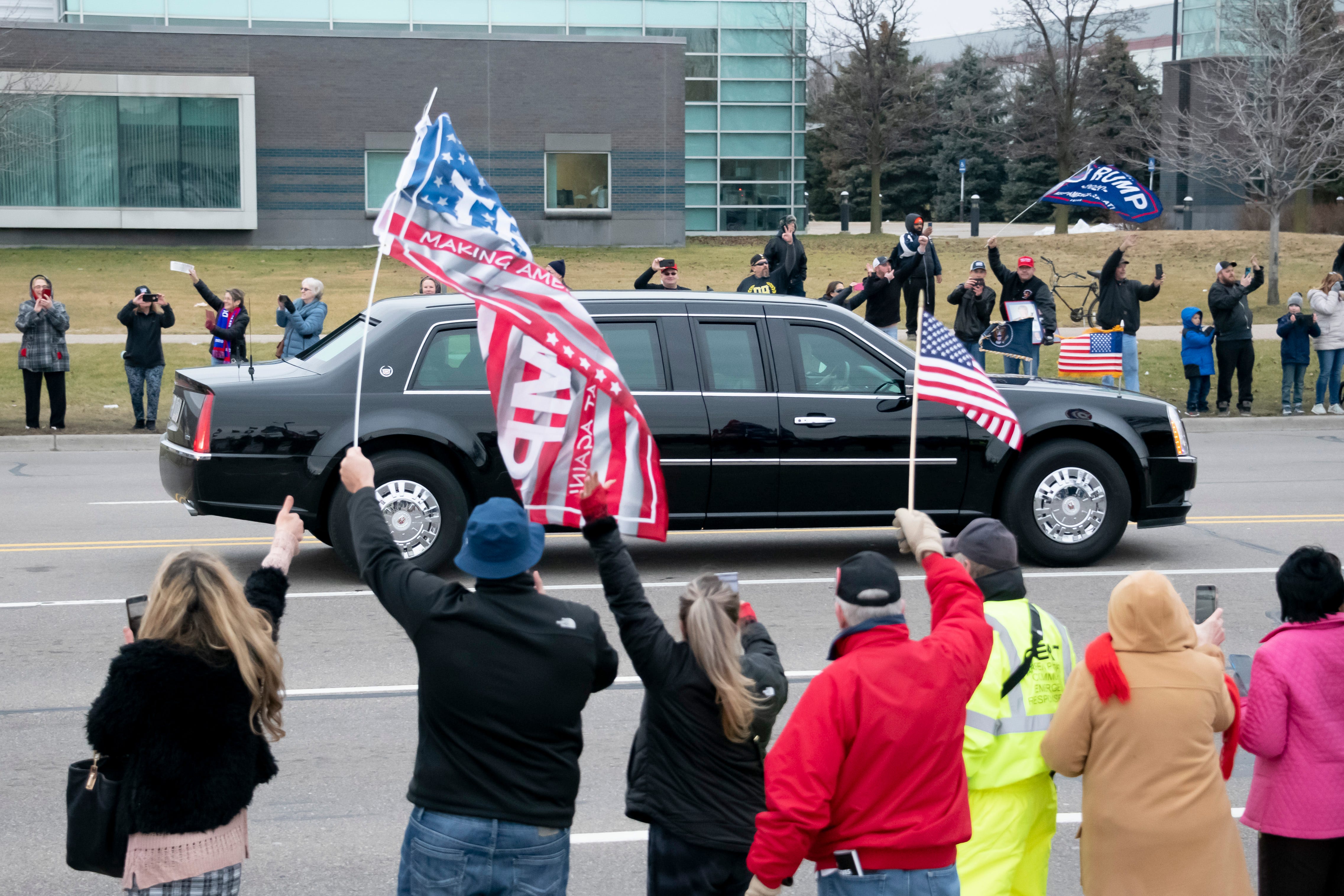 President Donald Trump's motorcade passes supporters along Van Dyke.