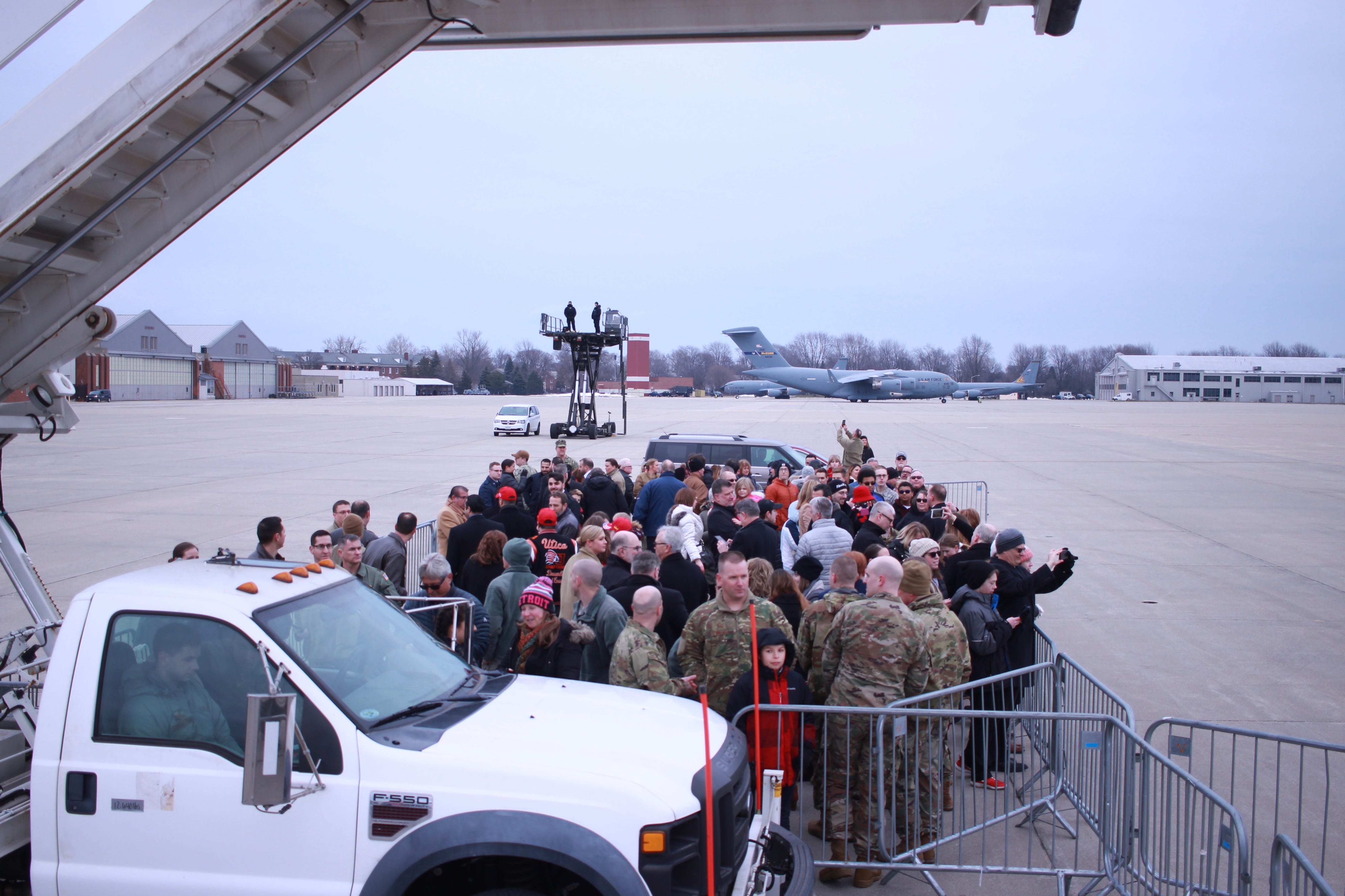 A crowd of people, including soldiers, await President Donald Trump's arrival at Selfridge Air Base in Harrison Township on Thursday.