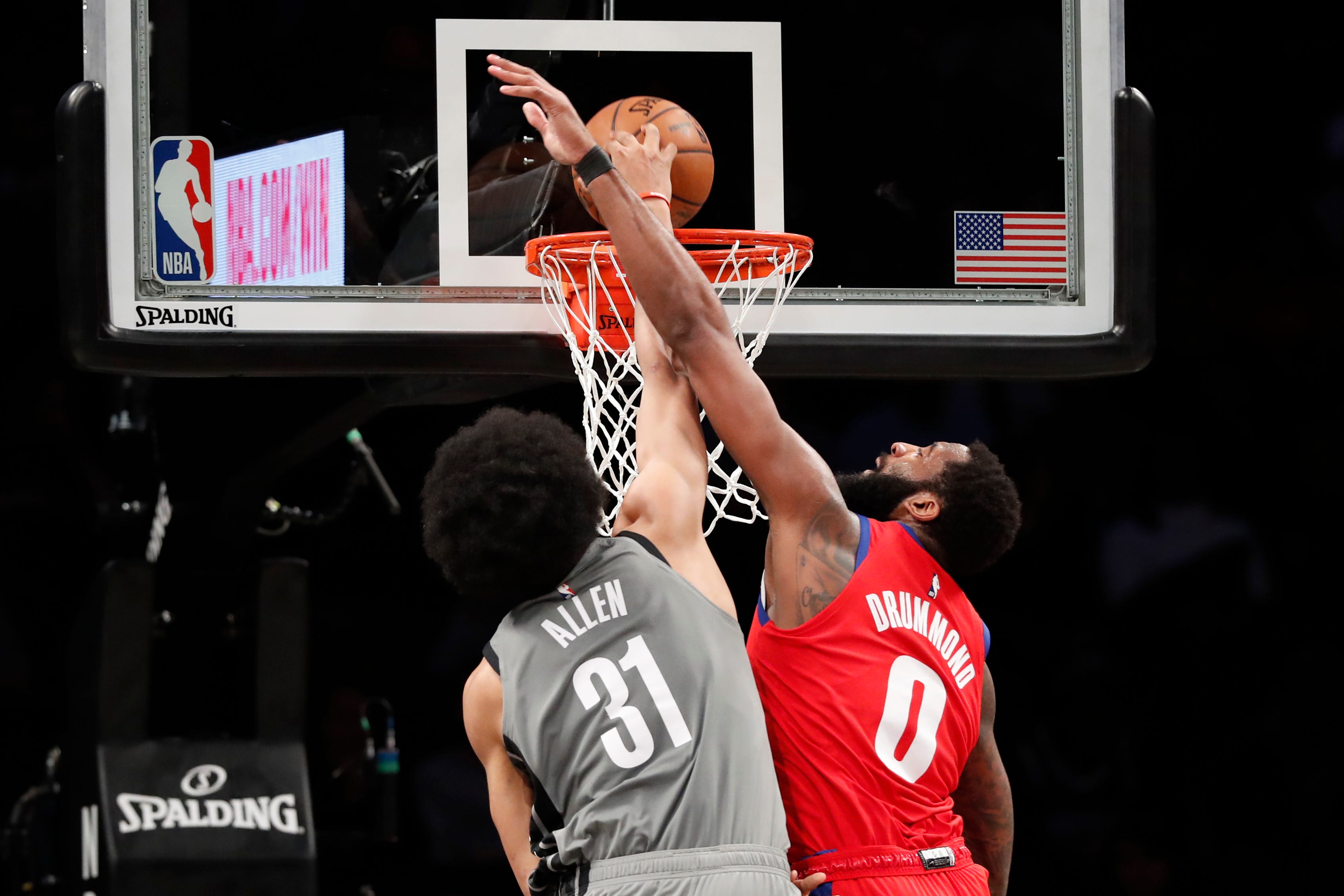Detroit Pistons center Andre Drummond fouls Brooklyn Nets center Jarrett Allen who dunks during the first half.