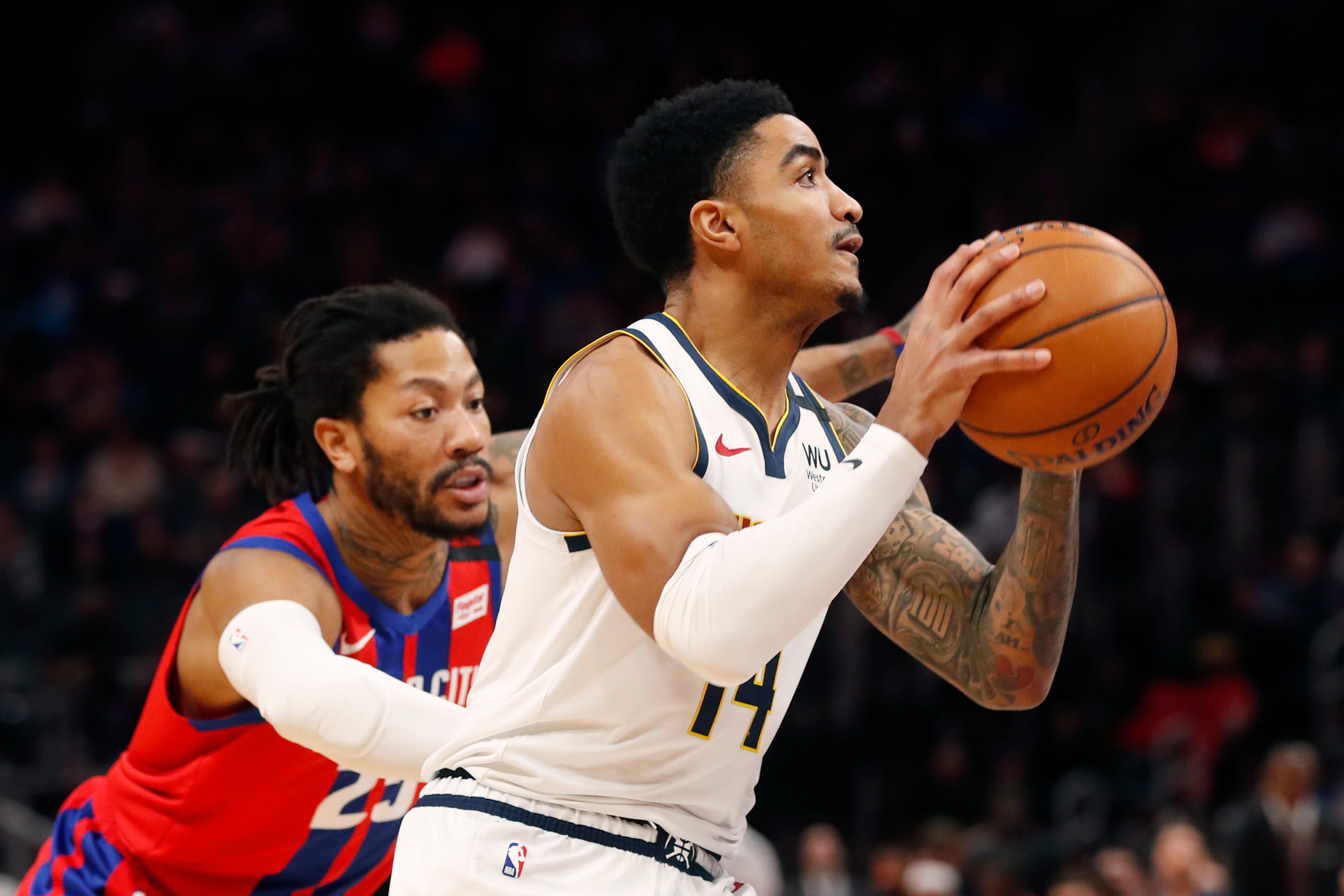 Detroit Pistons guard Derrick Rose (25) reaches in on Denver Nuggets guard Gary Harris (14) during the first half.