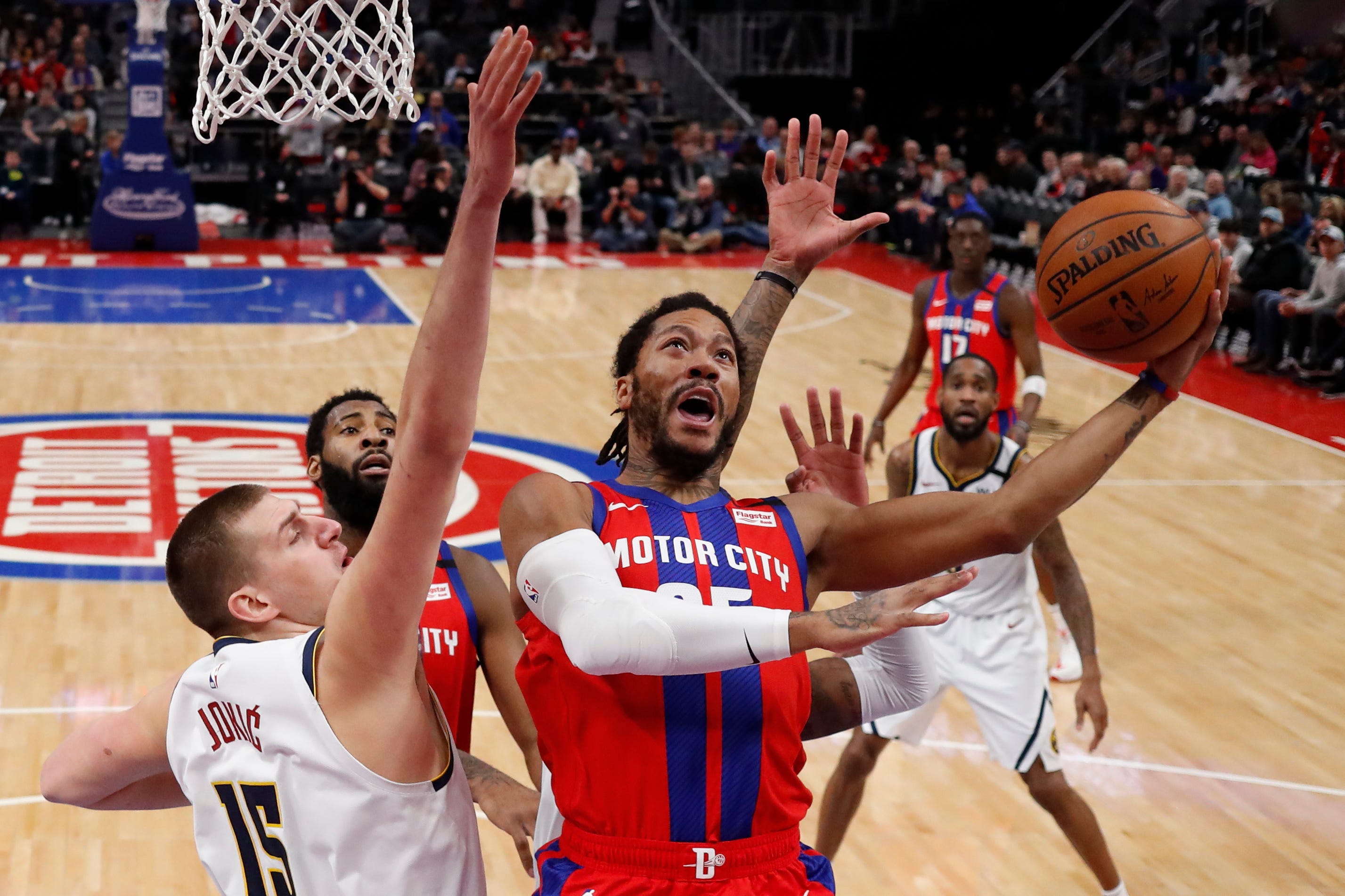 Detroit Pistons guard Derrick Rose attempts a layup as Denver Nuggets center Nikola Jokic (15) defends during the first half of an NBA basketball game, Sunday, Feb. 2, 2020, in Detroit. Detroit defeated Denver 128-123 in overtime.