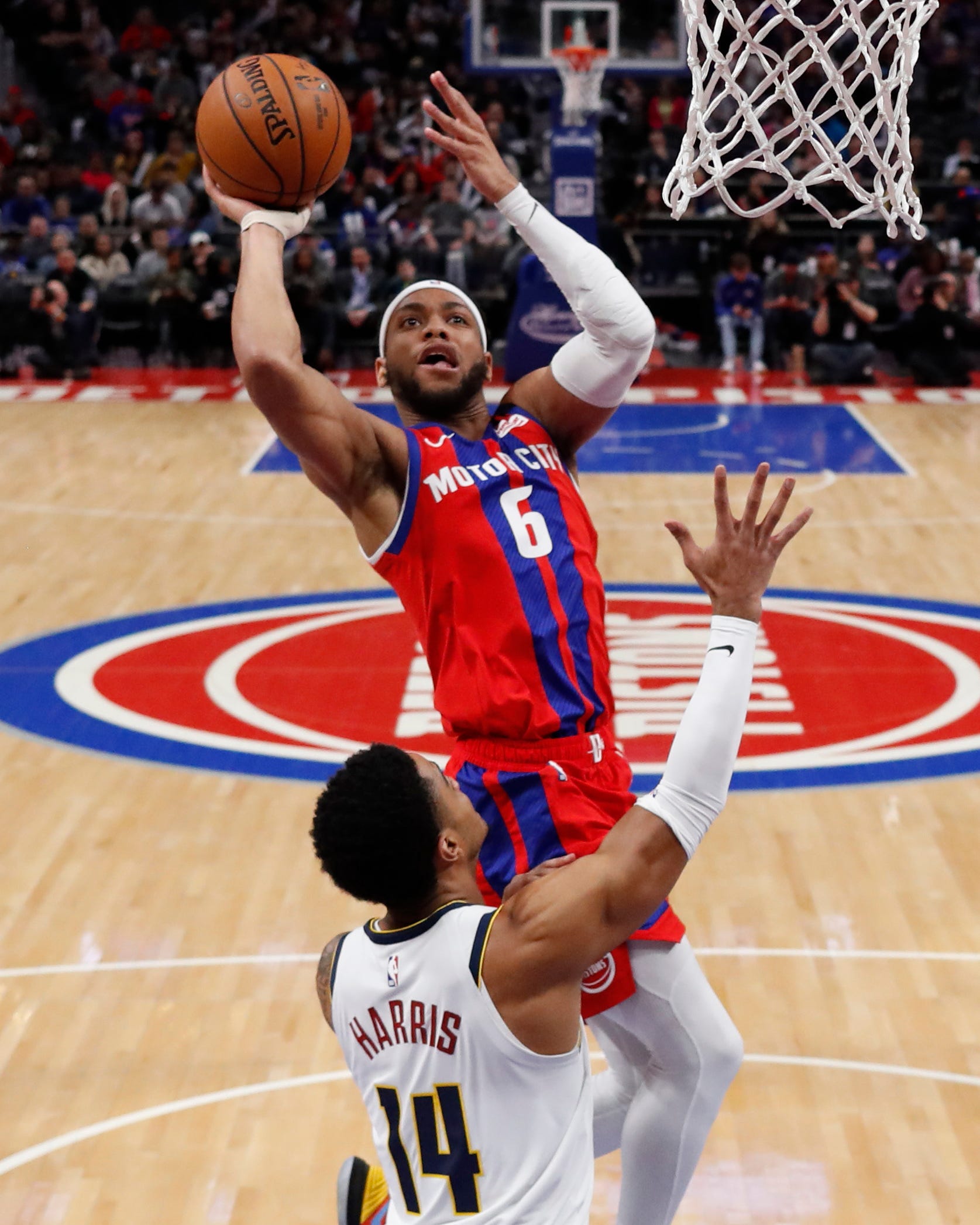 Detroit Pistons guard Bruce Brown (6) shoots as Denver Nuggets guard Gary Harris (14) defends during the first half.