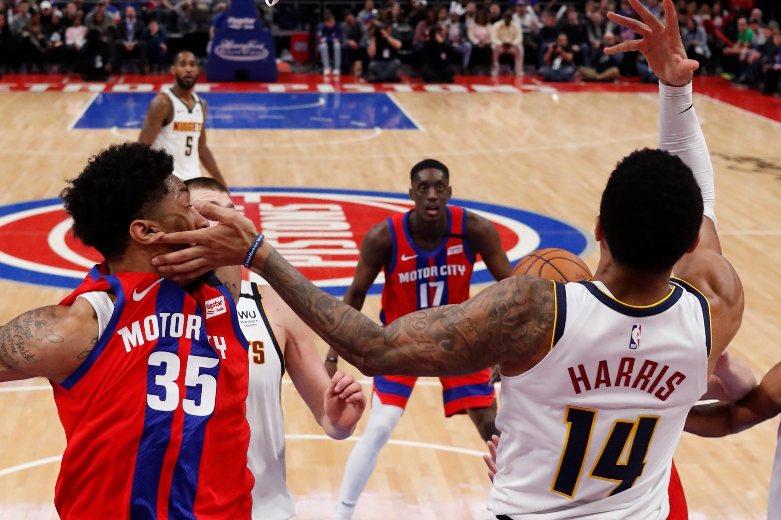 Denver Nuggets guard Gary Harris (14) looses control of the ball as hits Detroit Pistons forward Christian Wood (35) in the face during the second half.
