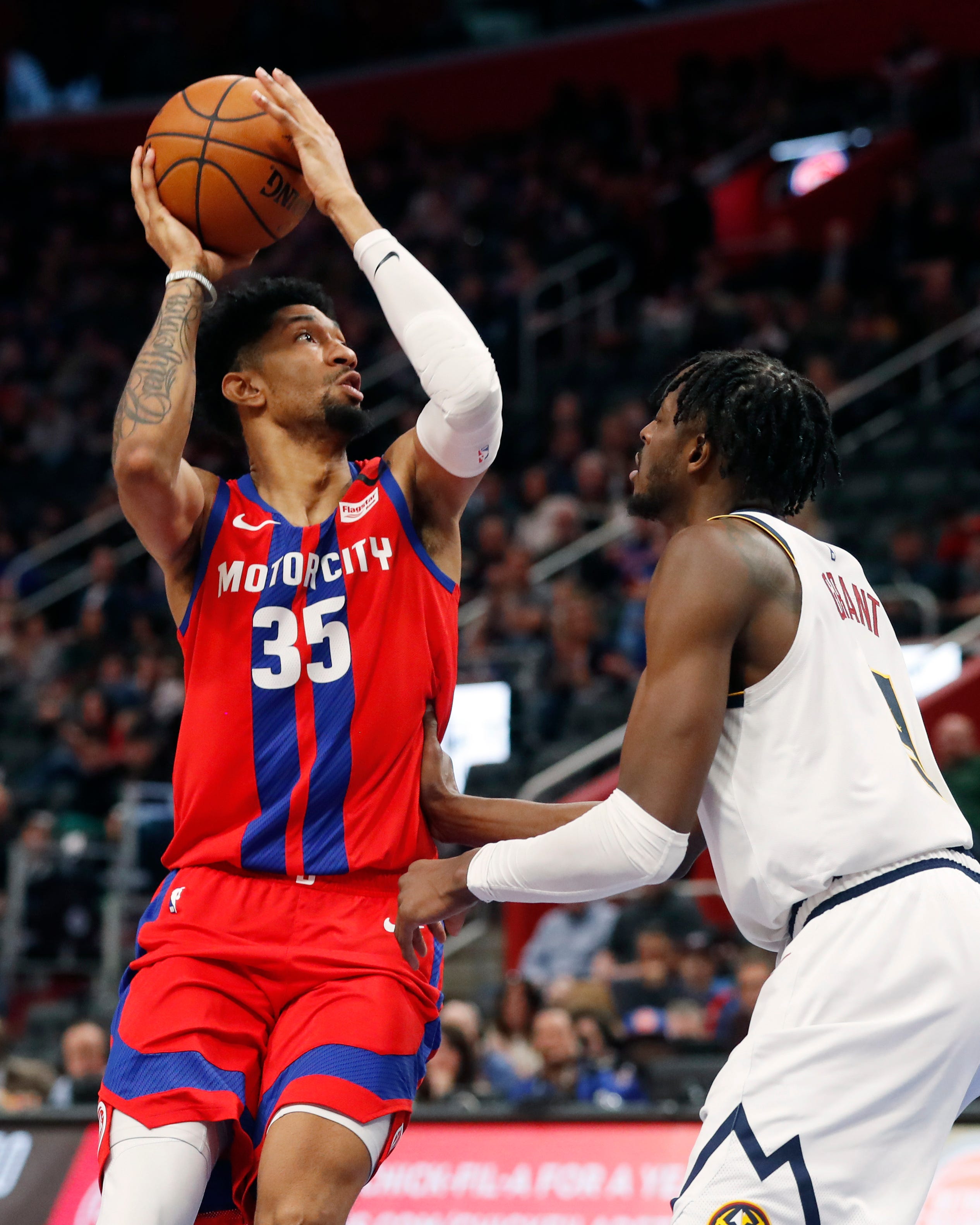 Detroit Pistons forward Christian Wood (35) shoots over Denver Nuggets forward Jerami Grant during the second half.