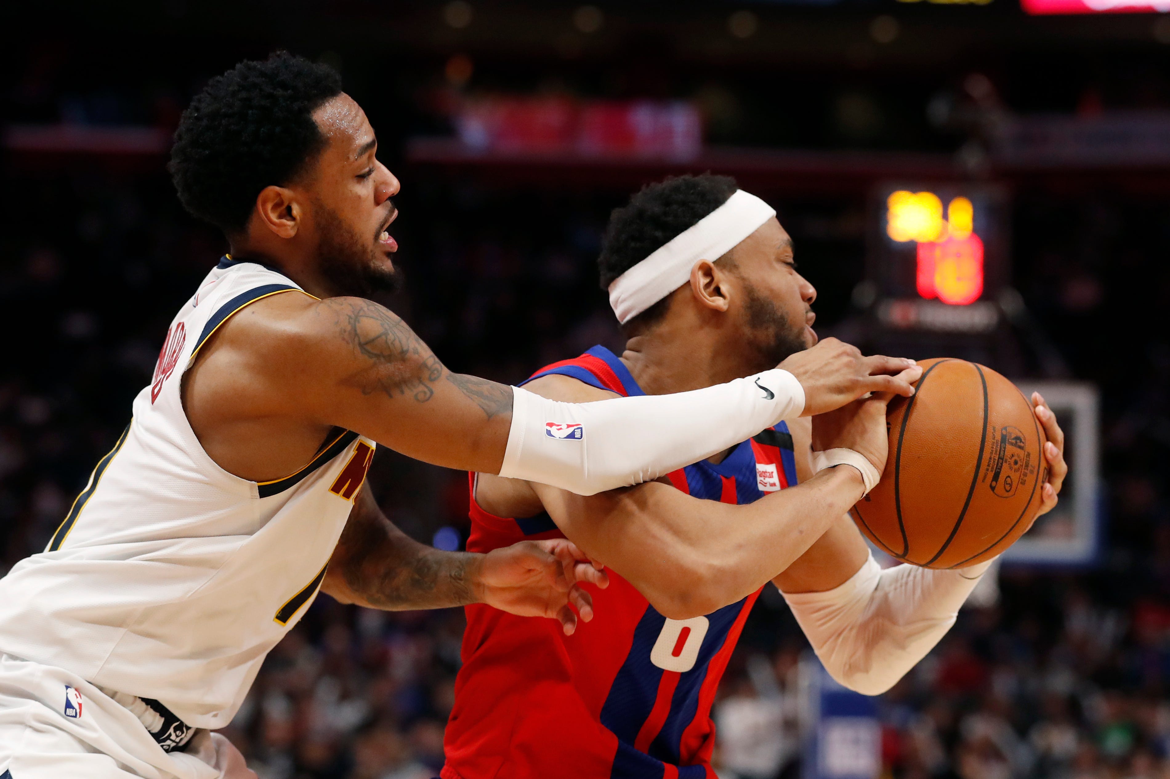 Denver Nuggets guard Monte Morris, left, reaches in against Detroit Pistons guard Bruce Brown (6) during the second half.