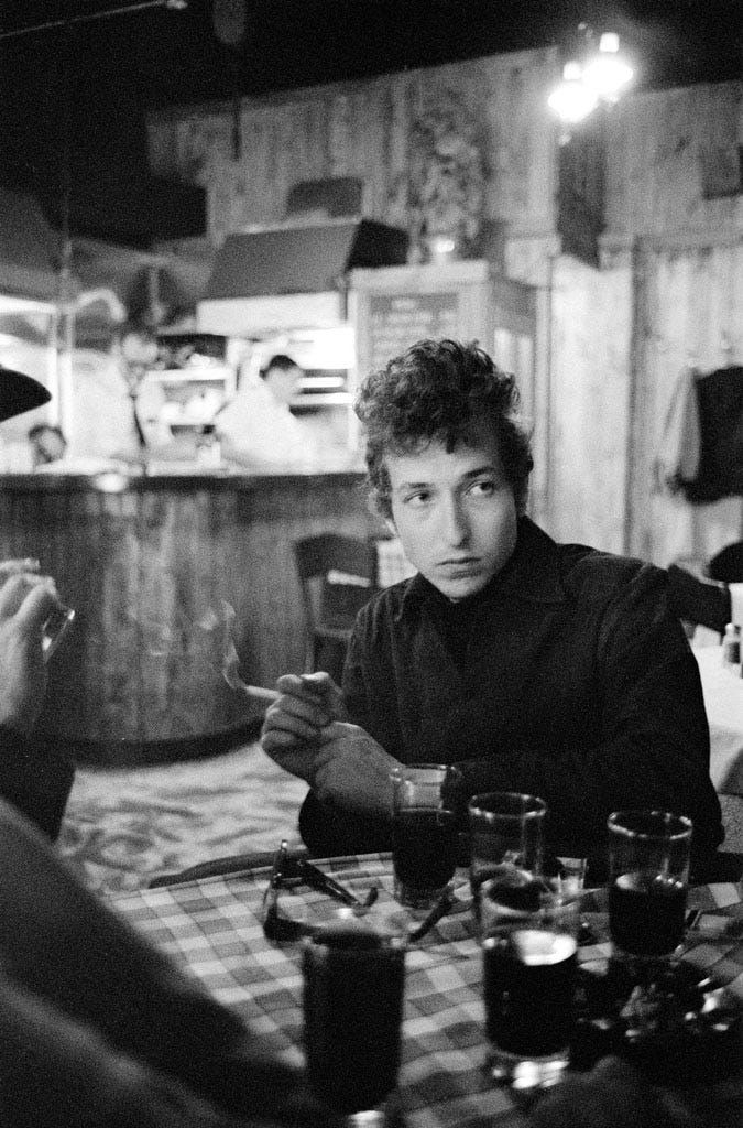 Bob Dylan smokes at the Kettle of Fish Bar, Greenwich Village, NY
1964.