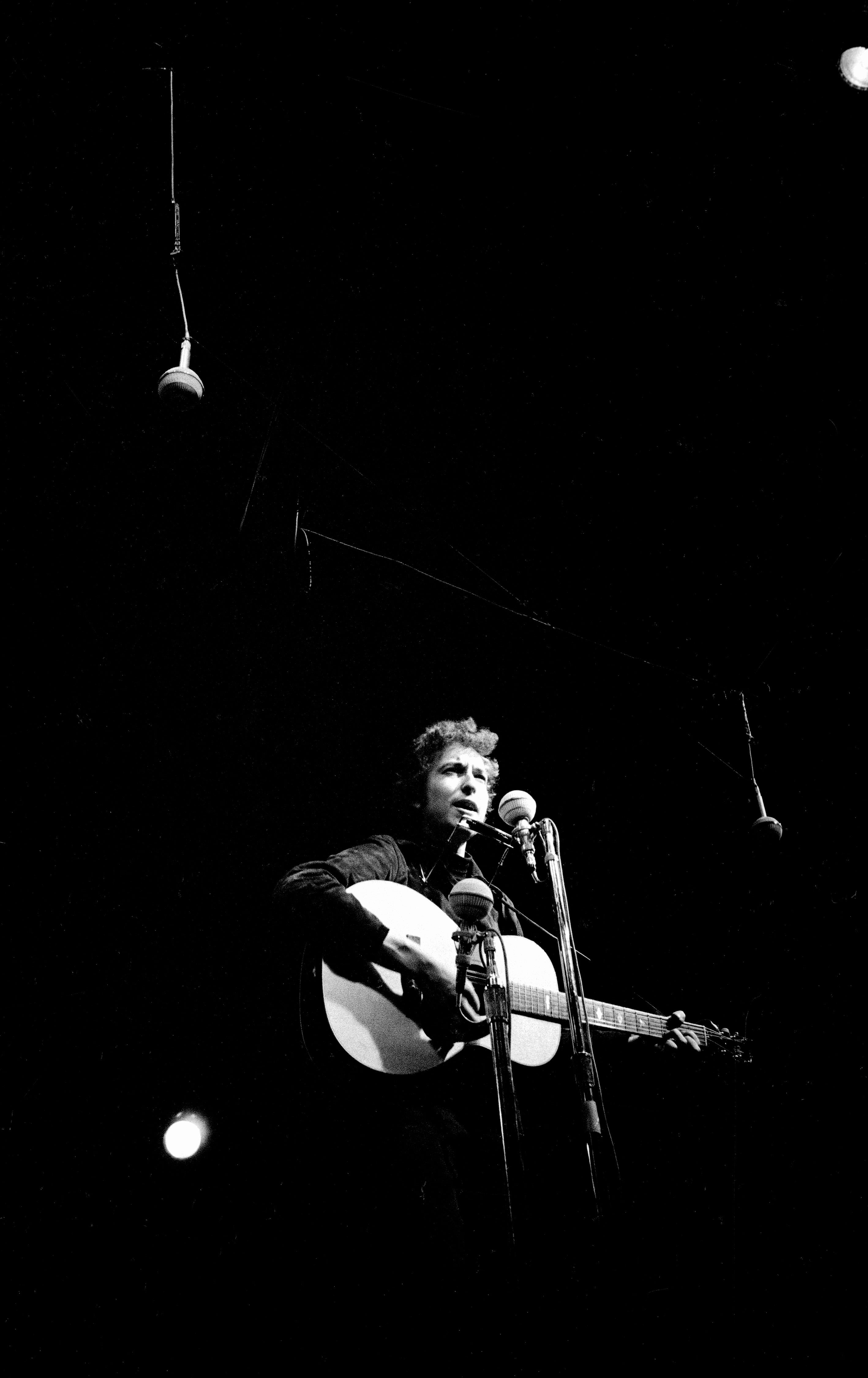 A night time performance by Bob Dylan at Newport Folk Festival, Newport, Rhode Island, 1964