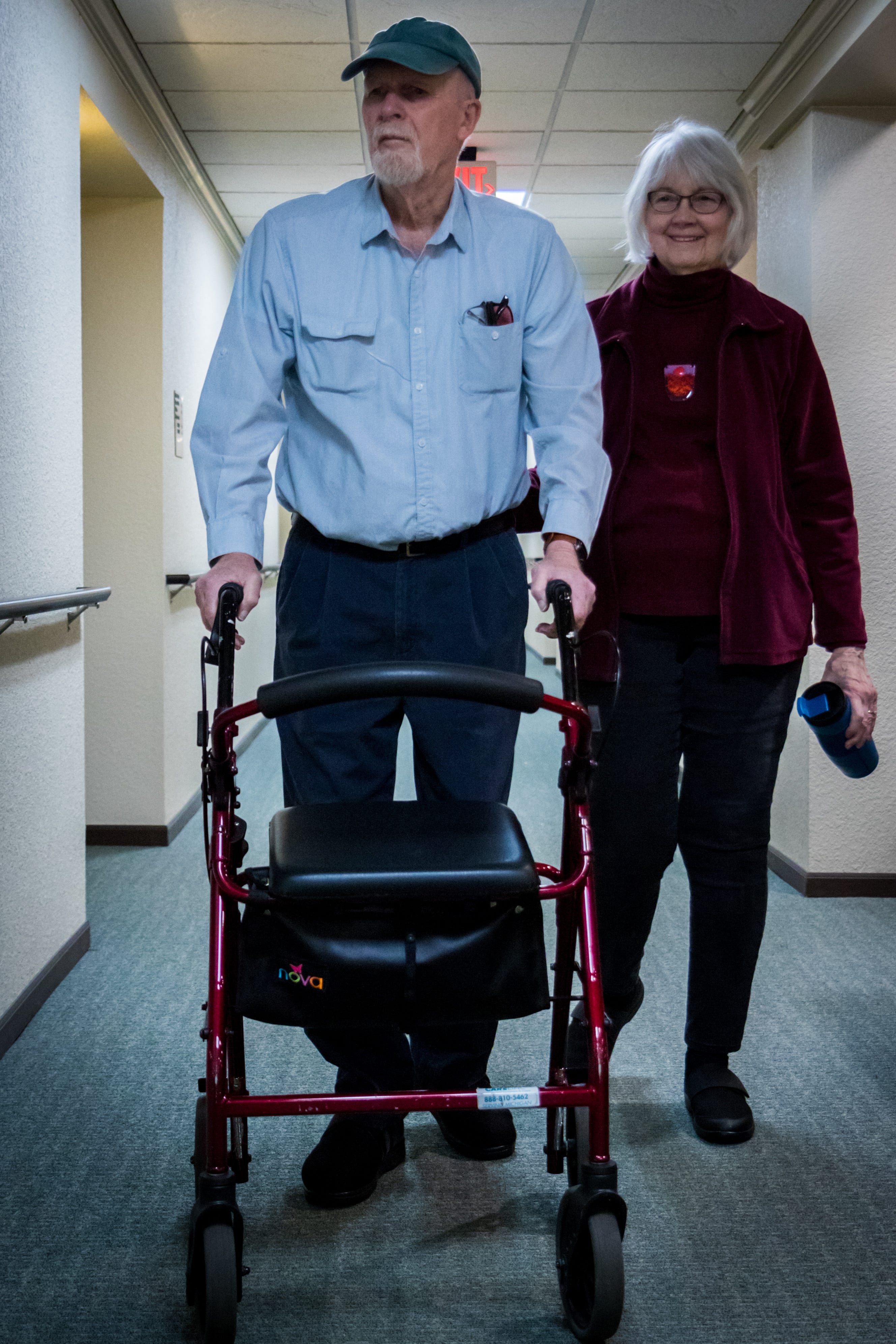 Douglas and Barbara Gilbert walk down the hallway of their home in Grand Haven, Michigan.