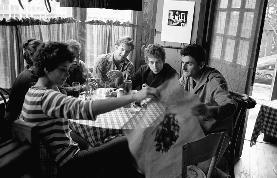(from left) Sara Lowndes, Mason Hoffenberg, John Sebastian, Bob Dylan and Victor Maymudes hang out at Cafe Espresso in Woodstock, NY circa 1964.