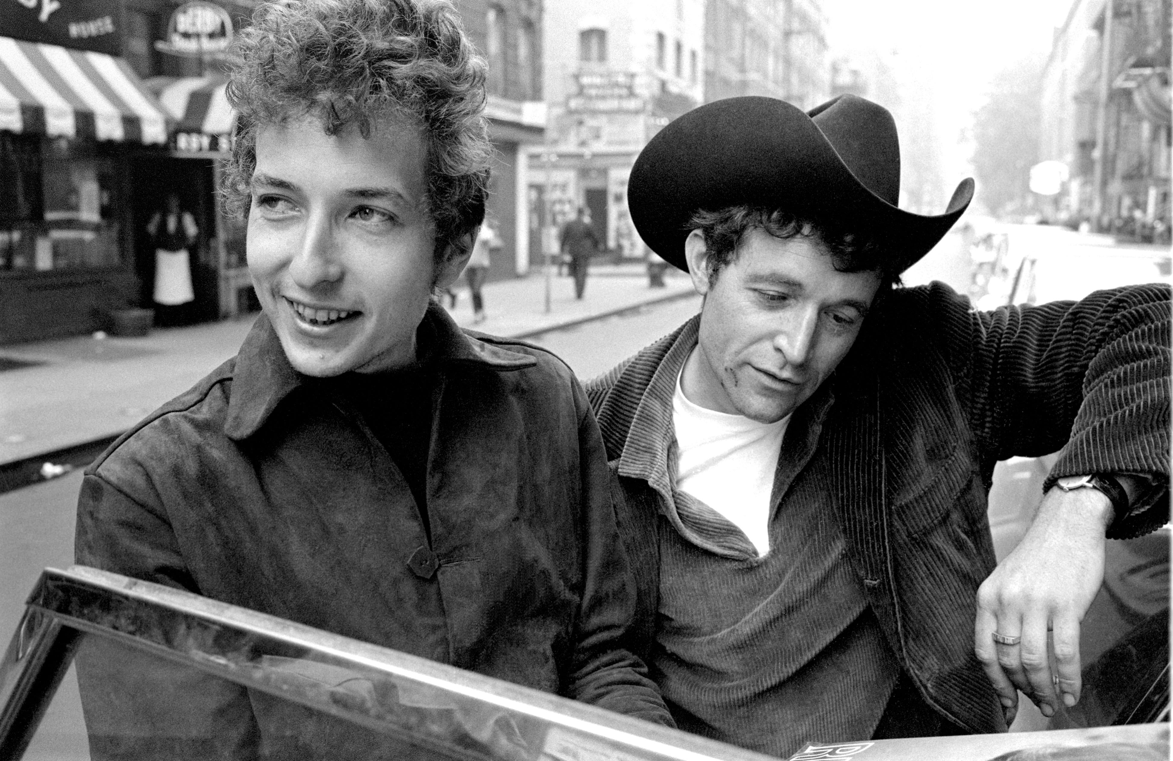 Photographer Douglas R. Gilbert captured this candid image of a young Bob Dylan and Ramblin' Jack Elliot in Greenwich Village, New York in 1964. Gilbert photographed Bob Dylan for LOOK magazine in 1964, spending time with him at his home in Woodstock, New York, in Greenwich Village, and at the Newport Folk Festival.  After reviewing the proposed layout, the editors of LOOK declared Dylan to be “too scruffy for a family magazine” and killed the story.