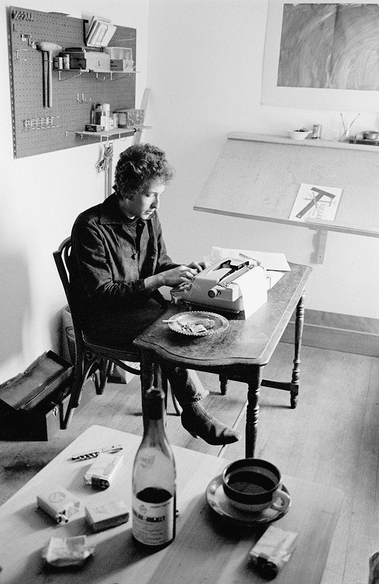 Bob Dylan works in the writing room above Cafe Espresso in Woodstock, NY (1964)