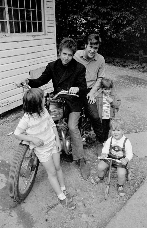 Bob Dylan and John Sebastian on Dylans' Triumph with the Paturel children in the alley behind the Cafe Espresso, Woodstock, NY, 1964