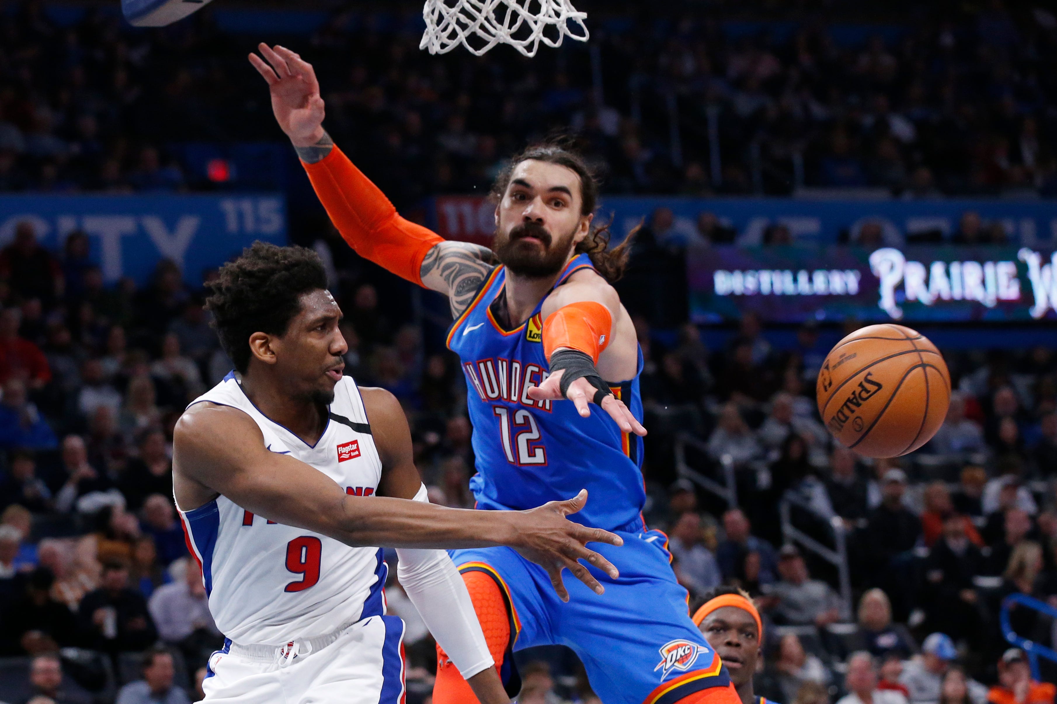 Detroit Pistons guard Langston Galloway (9) passes the ball around Oklahoma City Thunder center Steven Adams (12) during the first half.