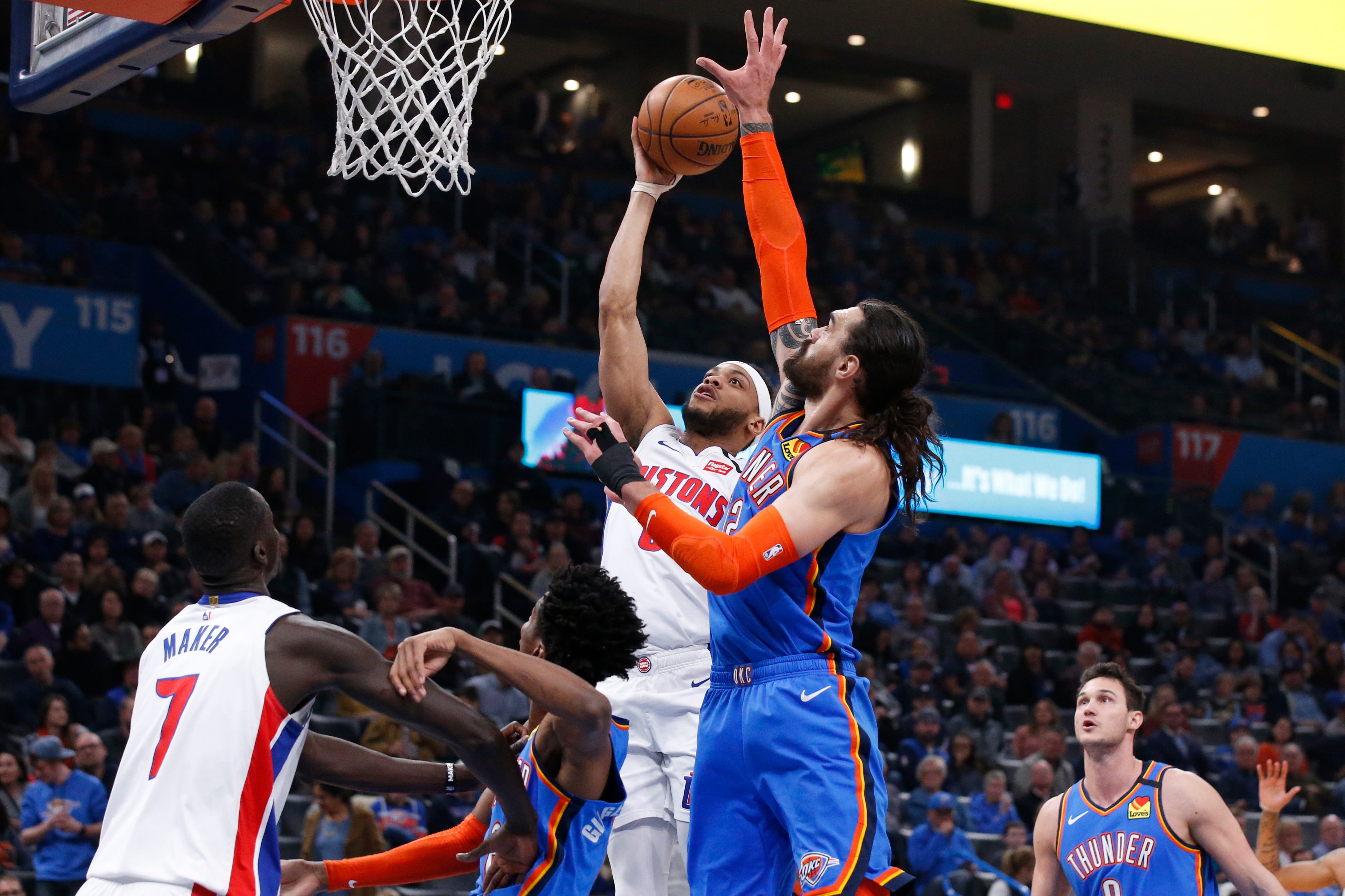 Detroit Pistons guard Bruce Brown, top left, shoots as Oklahoma City Thunder center Steven Adams defends during the first half of an NBA basketball game.